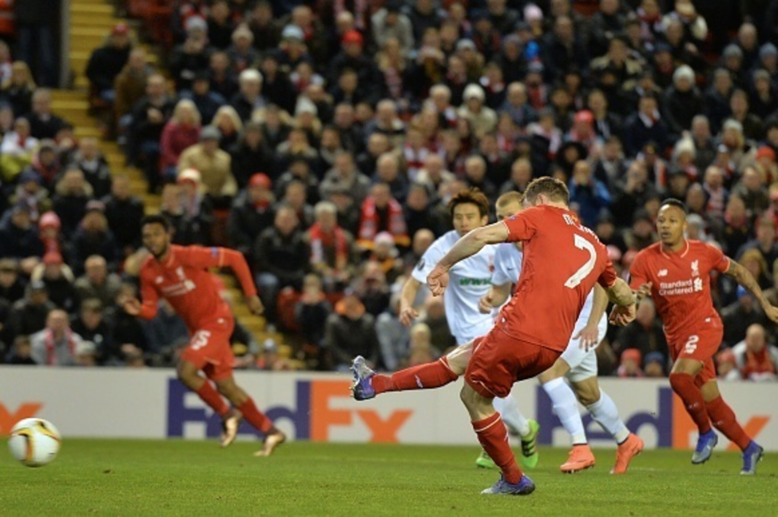Liverpool's English midfielder James Milner scores the opening goal from the penalty spot during the UEFA Europa League round of 32, second leg football match between Liverpool and Augsburg at Anfield in Liverpool, north west England on February 25, 2016.
