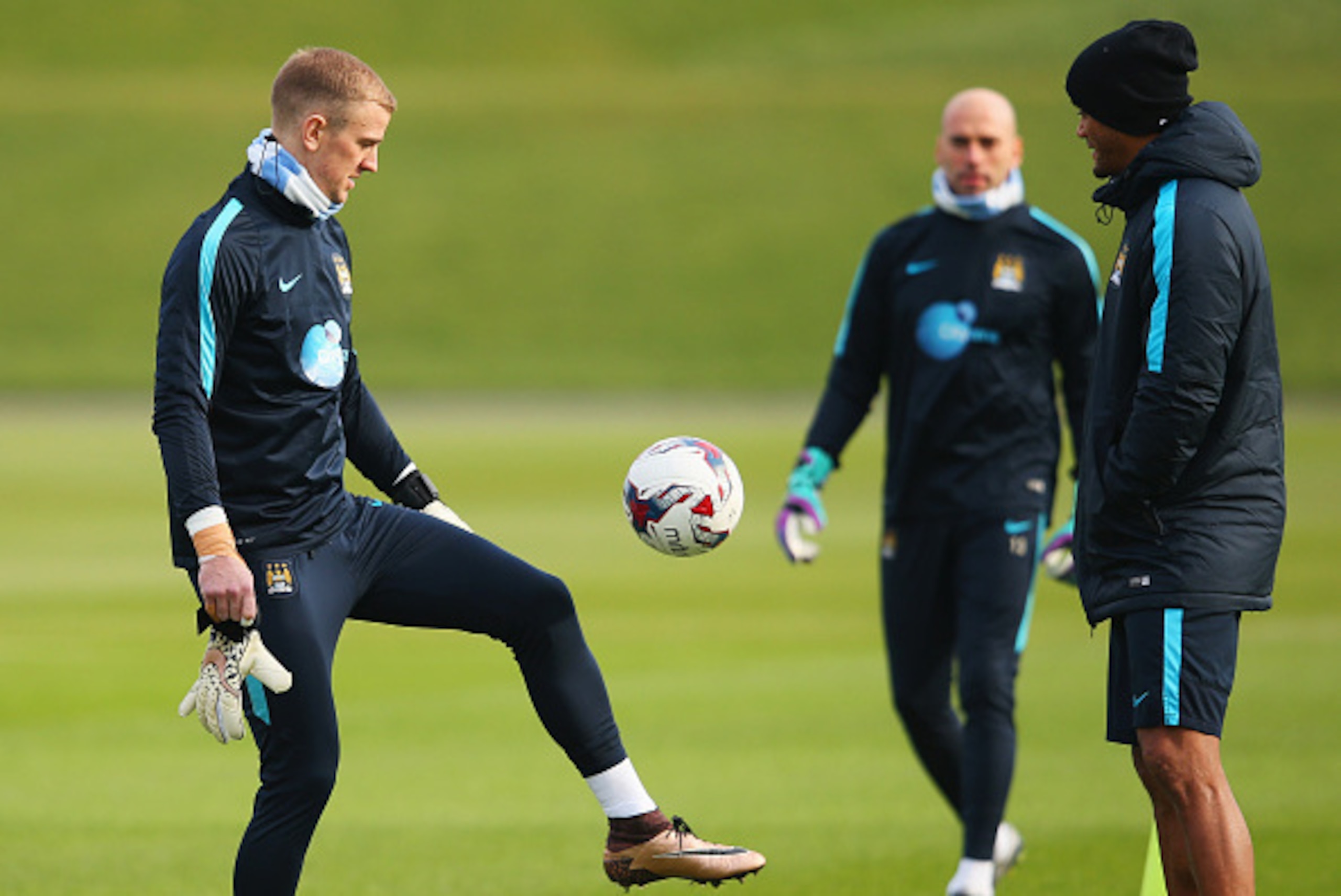 MANCHESTER, ENGLAND - FEBRUARY 26:  Joe Hart juggles as ball as Wilfredo Caballero and Vincent Kompany look on during a Manchester City training session at the City Football Academy on February 26, 2016 in Manchester, United Kingdom.  (Photo by Alex Lives