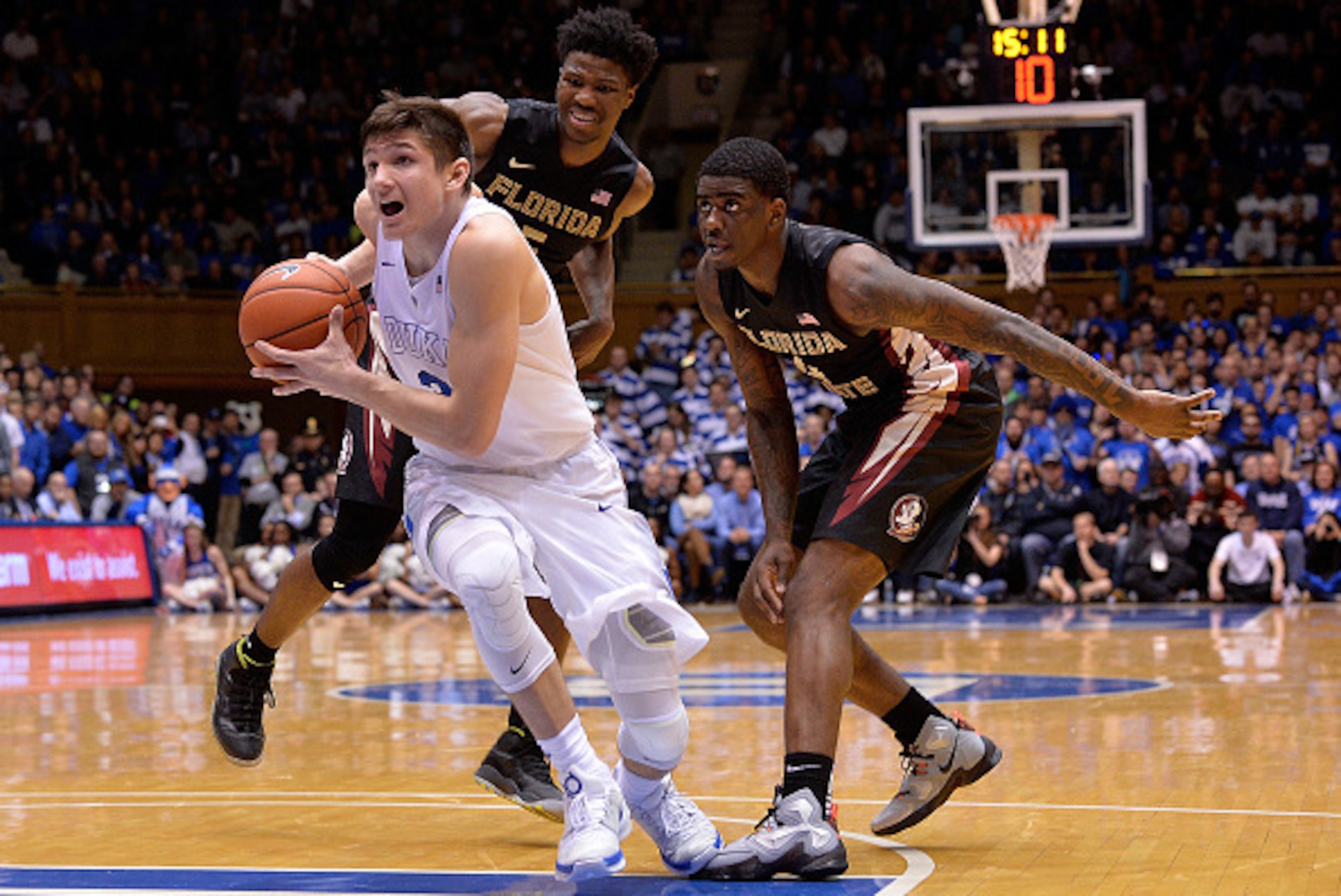 DURHAM, NC - FEBRUARY 25:  Grayson Allen #3 of the Duke Blue Devils drives past Malik Beasley #5 and Dwayne Bacon #4 of the Florida State Seminoles during their game at Cameron Indoor Stadium on February 25, 2016 in Durham, North Carolina. Duke won 80-65.