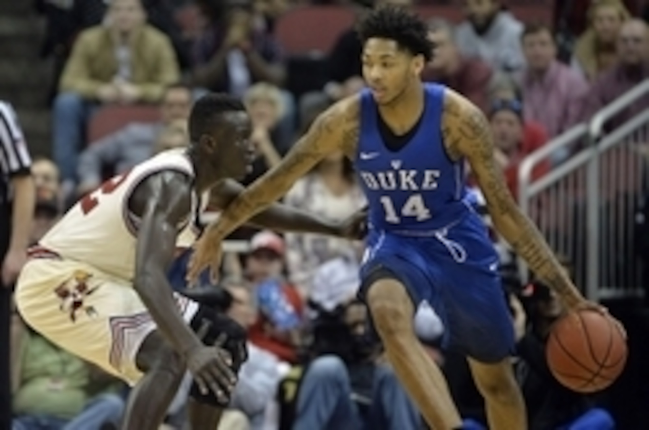 Feb 20, 2016; Louisville, KY, USA; Duke Blue Devils guard Brandon Ingram (14) dribbles the ball around Louisville Cardinals forward Deng Adel (22) during the second half at KFC Yum! Center. The Cardinals won 71-64. Mandatory Credit: Jamie Rhodes-USA TODAY