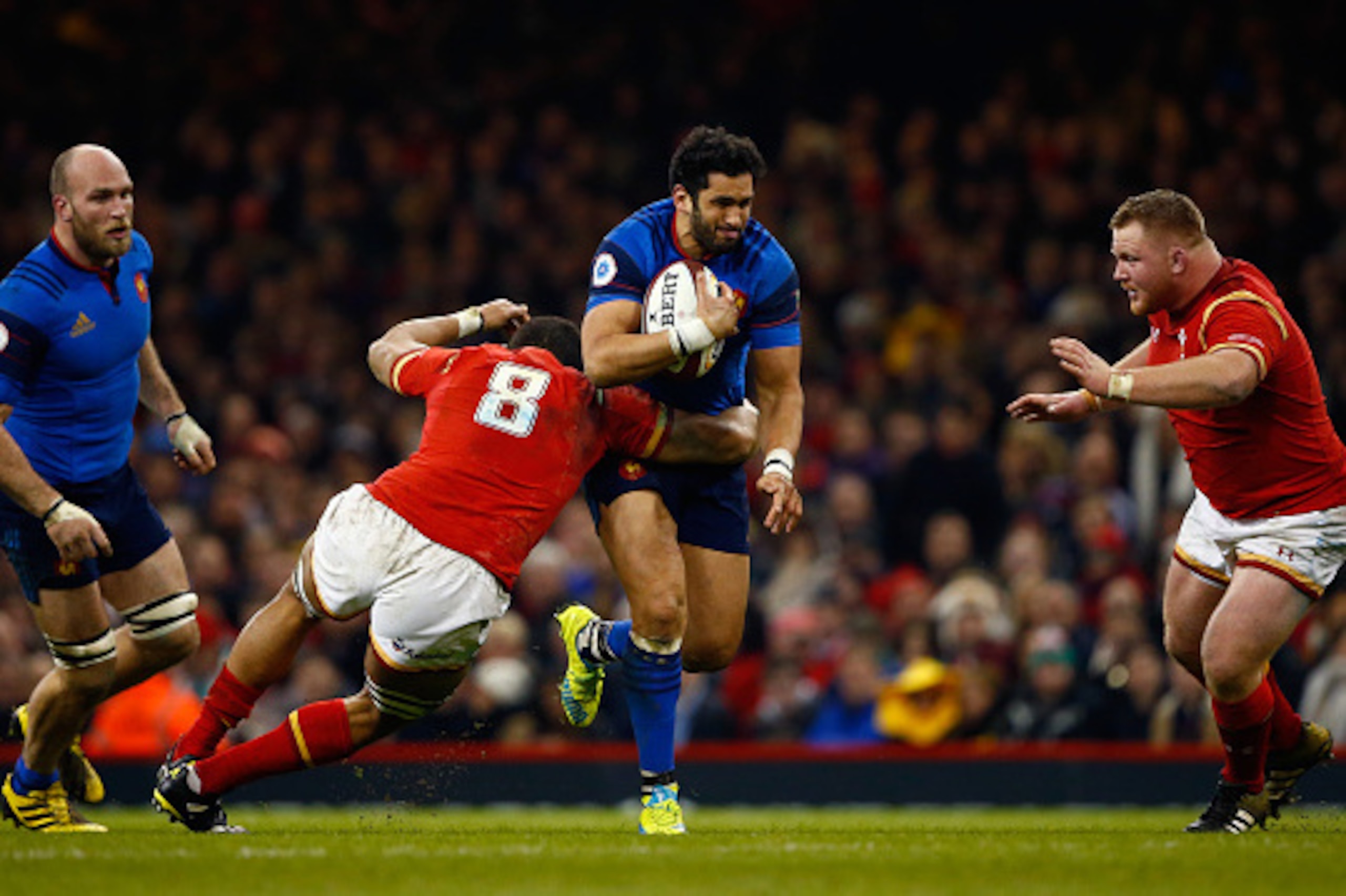 CARDIFF, WALES - FEBRUARY 26:  Maxime Mermoz of France is tackled by Taulupe Faletau and Samson Lee of Wales during the RBS Six Nations match between Wales and France at the Principality Stadium on February 26, 2016 in Cardiff, Wales.  (Photo by Julian Fi
