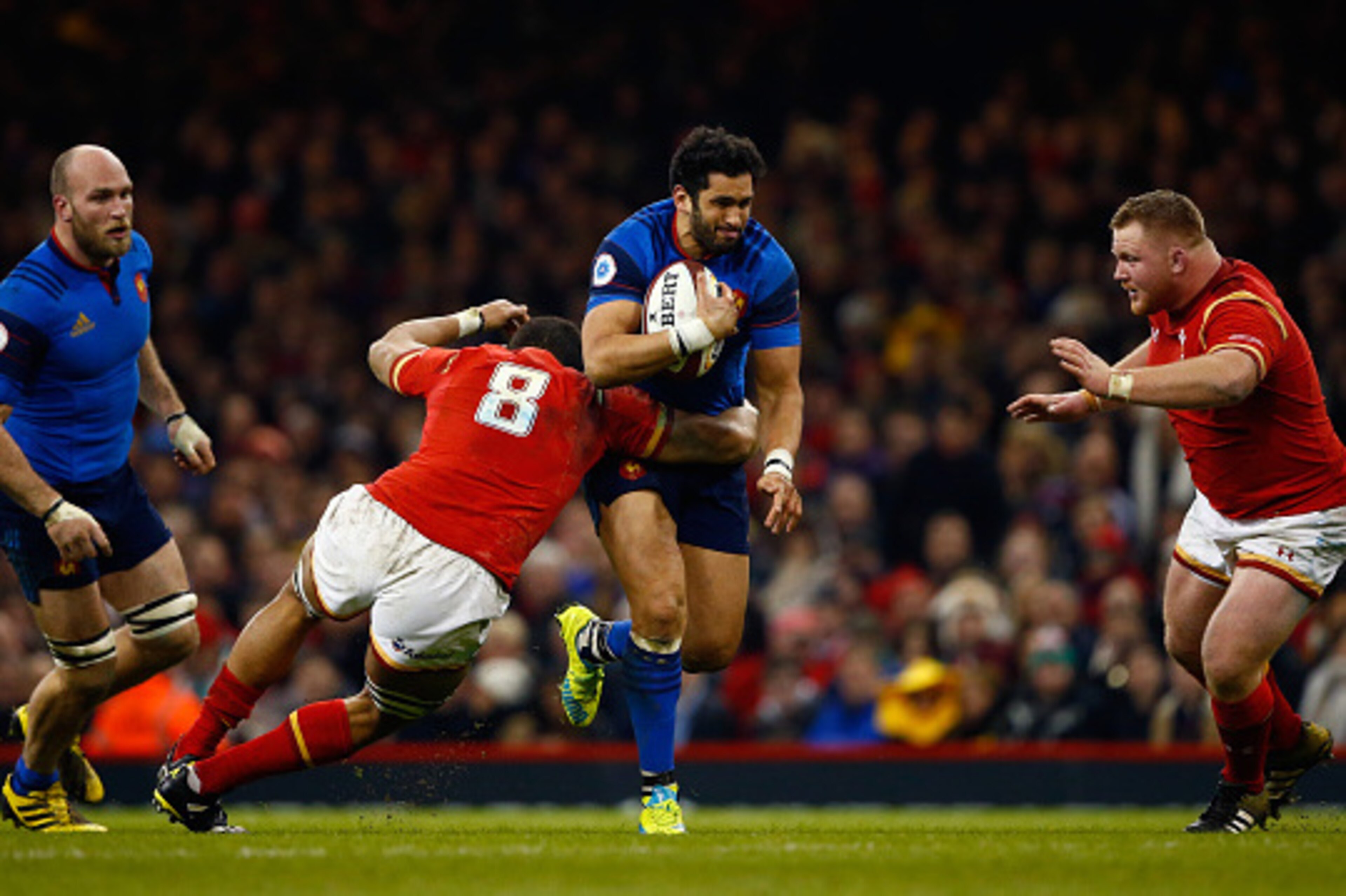 CARDIFF, WALES - FEBRUARY 26:  Maxime Mermoz of France is tackled by Taulupe Faletau and Samson Lee of Wales during the RBS Six Nations match between Wales and France at the Principality Stadium on February 26, 2016 in Cardiff, Wales.  (Photo by Julian Fi
