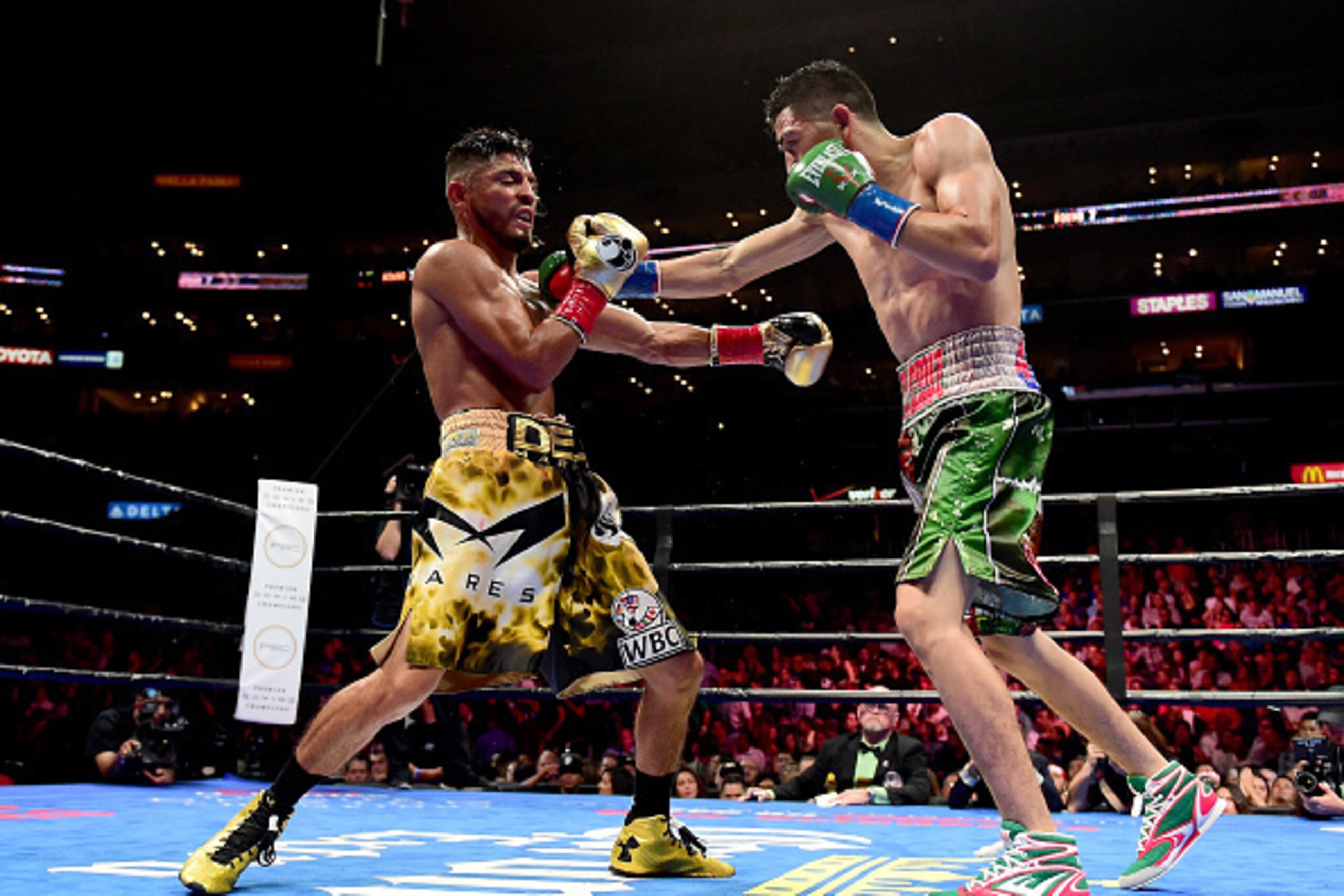 LOS ANGELES, CA - AUGUST 29:  Leo Santa Cruz punches Abner Mares of Mexico during the seventh round of the WBC diamond featherweight and WBA featherweight championship bout at Staples Center on August 29, 2015 in Los Angeles, California.  Santa Cruz would