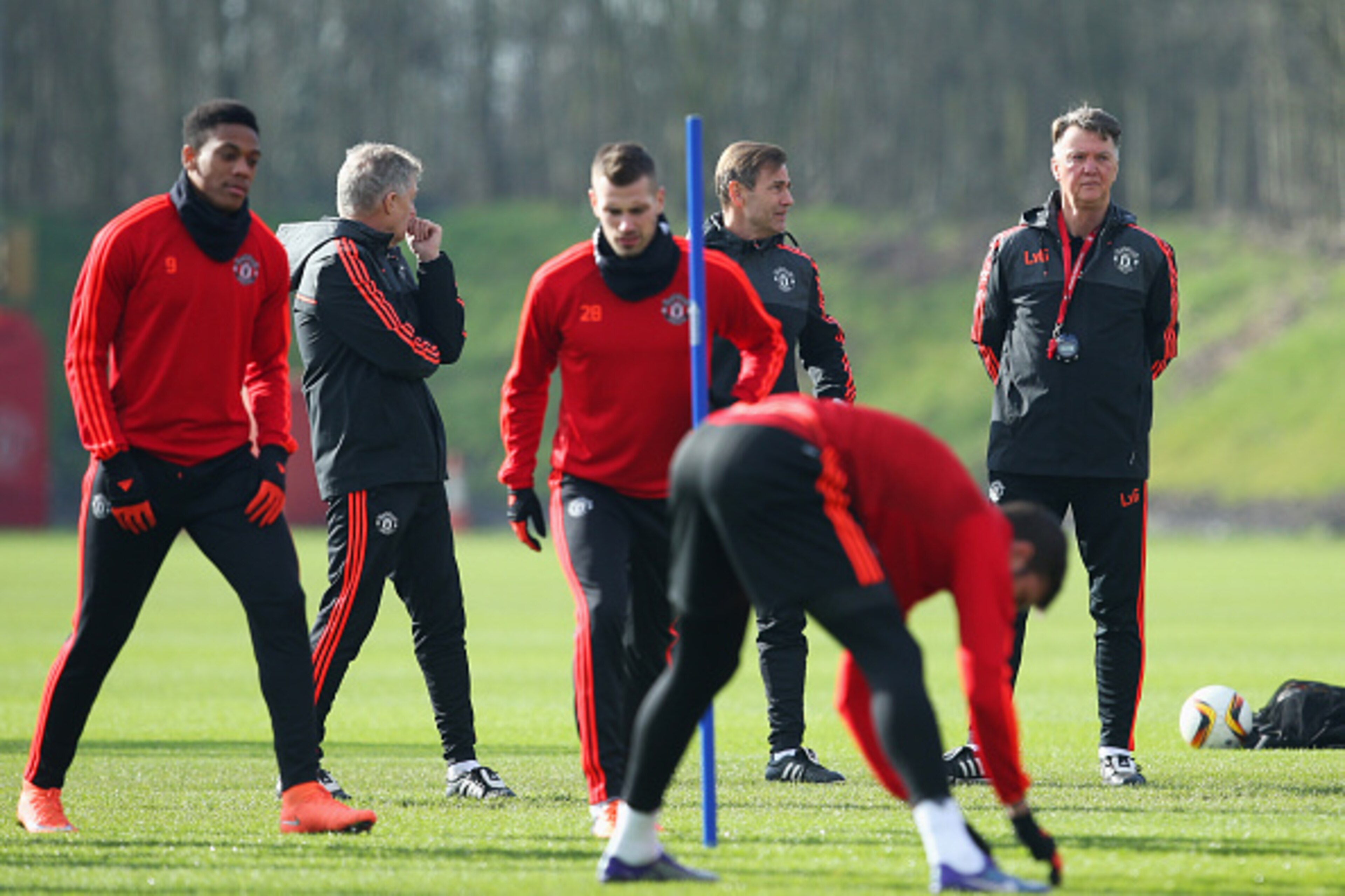 MANCHESTER, ENGLAND - FEBRUARY 24:  Louis van Gaal manager of Manchester United (R) watches players warm up during a Manchester United training session ahead of their UEFA Europa League round of 32 second leg match against FC Midtjylland at the Aon Traini