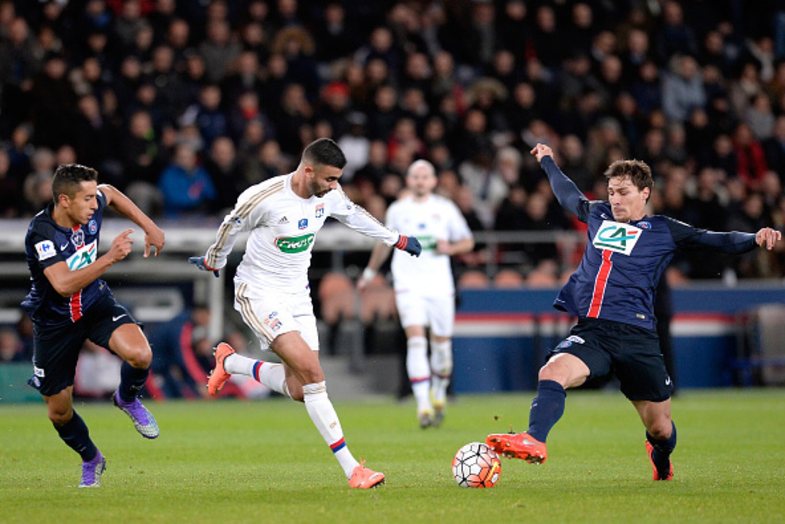 PARIS, FRANCE - FEBRUARY 10: Benjamin Stambouli (R) of Paris Saint-Germain and Rachid Ghezzal of Olympique Lyonnais fight for the ball during the French Cup game between the Paris Saint-Germain and Olympique Lyonnais at Parc des Princes on February 10, 20