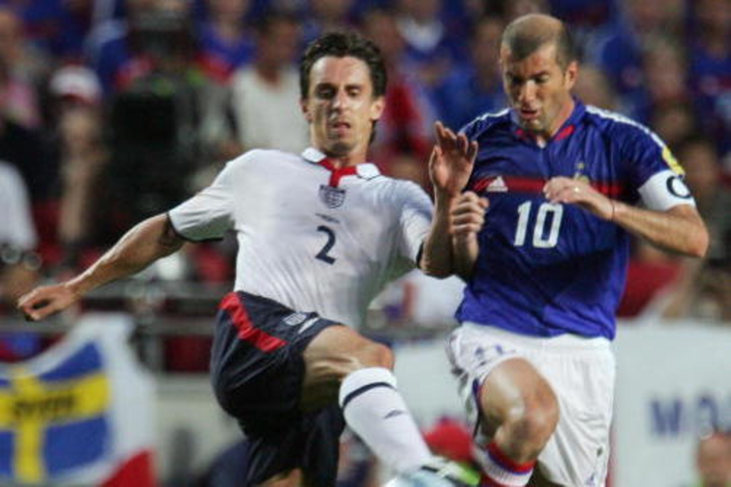 LISBON, Portugal: England defender Gary Neville (L) tackles French captain Zinedine Zidane, 13 June 2004 during their opening match at the European Nations football championships at the Estadio da Luz in Lisbon. France and England are competing in Group LISBON, Portugal: England defender Gary Neville (L) tackles French captain Zinedine Zidane, 13 June 2004 during their opening match at the European Nations football championships at the Estadio da Luz in Lisbon. France and England are competing in Group