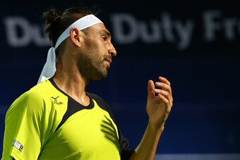 Marcos Baghdatis of Cyprus reacts after losing a point against Stanislas Wawrinka of Switzerland during their ATP final tennis match of the Dubai Duty Free Tennis Championships on February 27, 2016.      / AFP / MARWAN NAAMANI        (Photo credit should 