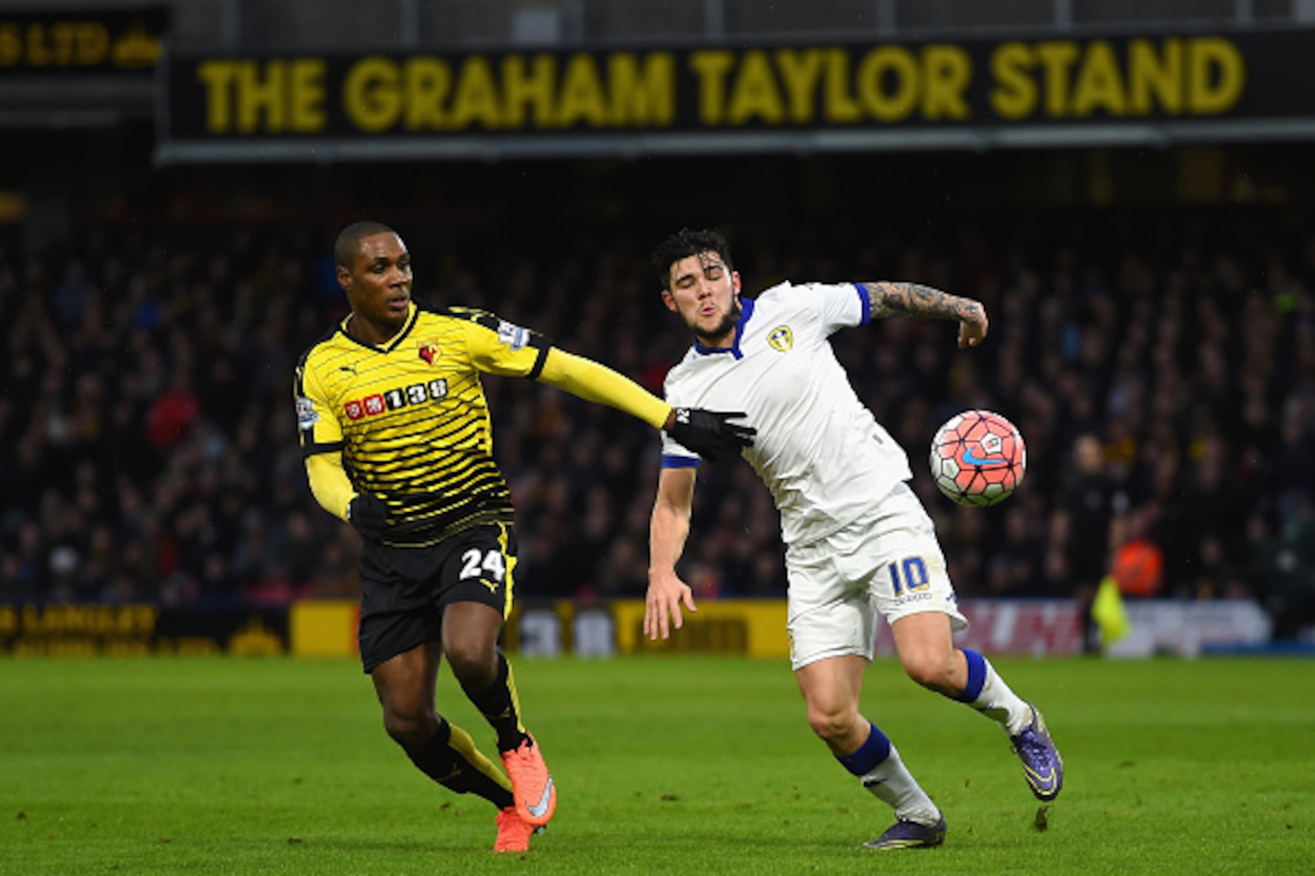 WATFORD, ENGLAND - FEBRUARY 20: Alex Mowatt of Leeds United and Odion Ighalo of Watford compete for the ball during the Emirates FA Cup fifth round match  between Watford and Leeds United at Vicarage Road on February 20, 2016 in Watford, England.  (Photo 