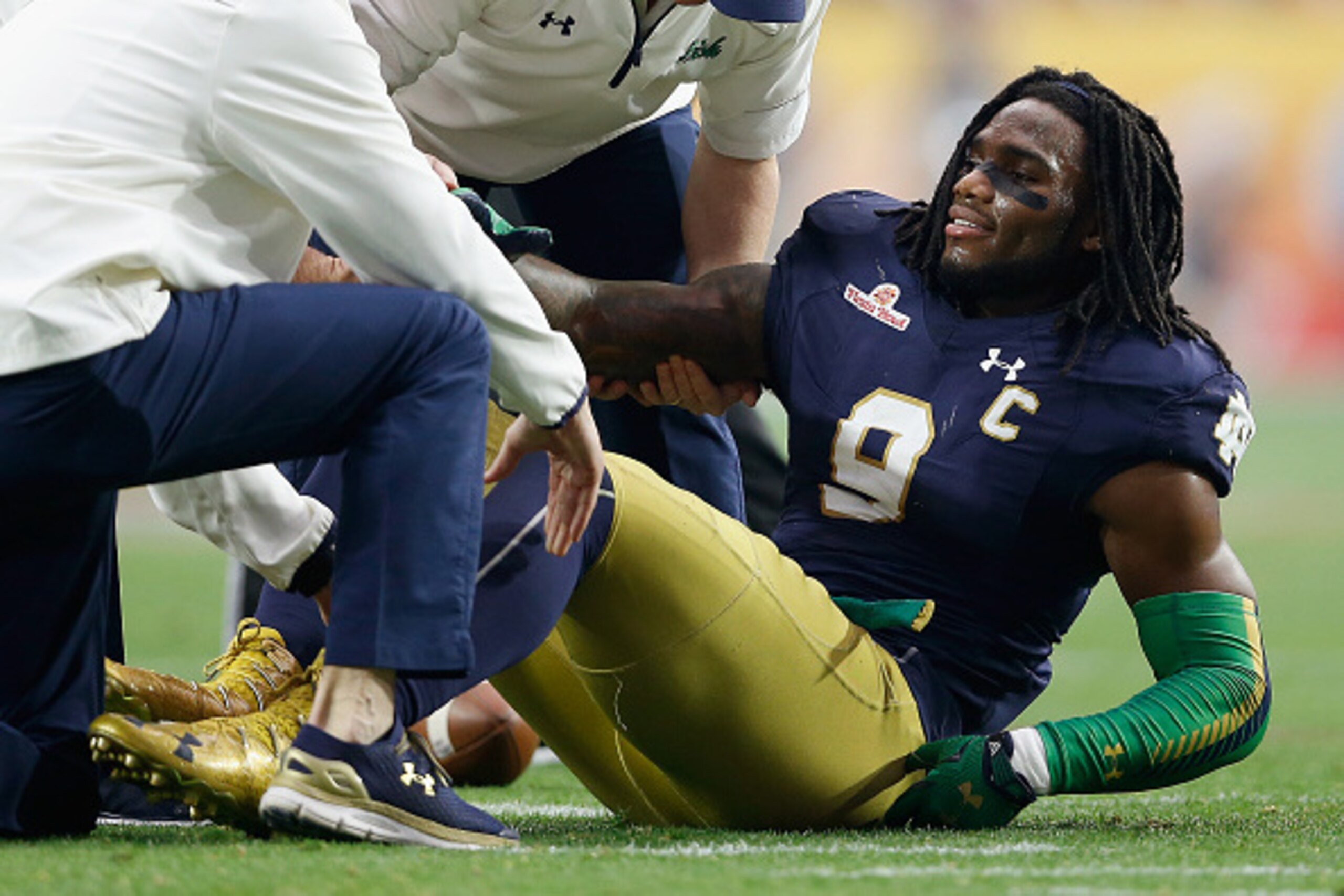 GLENDALE, AZ - JANUARY 01:  Linebacker Jaylon Smith #9 of the Notre Dame Fighting Irish lays on the field after an injury during the first quarter of the BattleFrog Fiesta Bowl against the Ohio State Buckeyes at University of Phoenix Stadium on January 1,