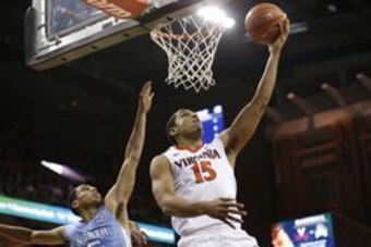 Feb 27, 2016; Charlottesville, VA, USA; Virginia Cavaliers guard Malcolm Brogdon (15) shoots the ball as North Carolina Tar Heels guard Marcus Paige (5) defends in the second half at John Paul Jones Arena. The Cavaliers won 79-74. Mandatory Credit: Geoff 