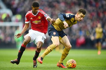 MANCHESTER, ENGLAND - FEBRUARY 28: Laurent Koscielny of Arsenal is closed down by Marcus Rashford of Manchester United during the Barclays Premier League match between Manchester United and Arsenal at Old Trafford on February 28, 2016 in Manchester, Engla