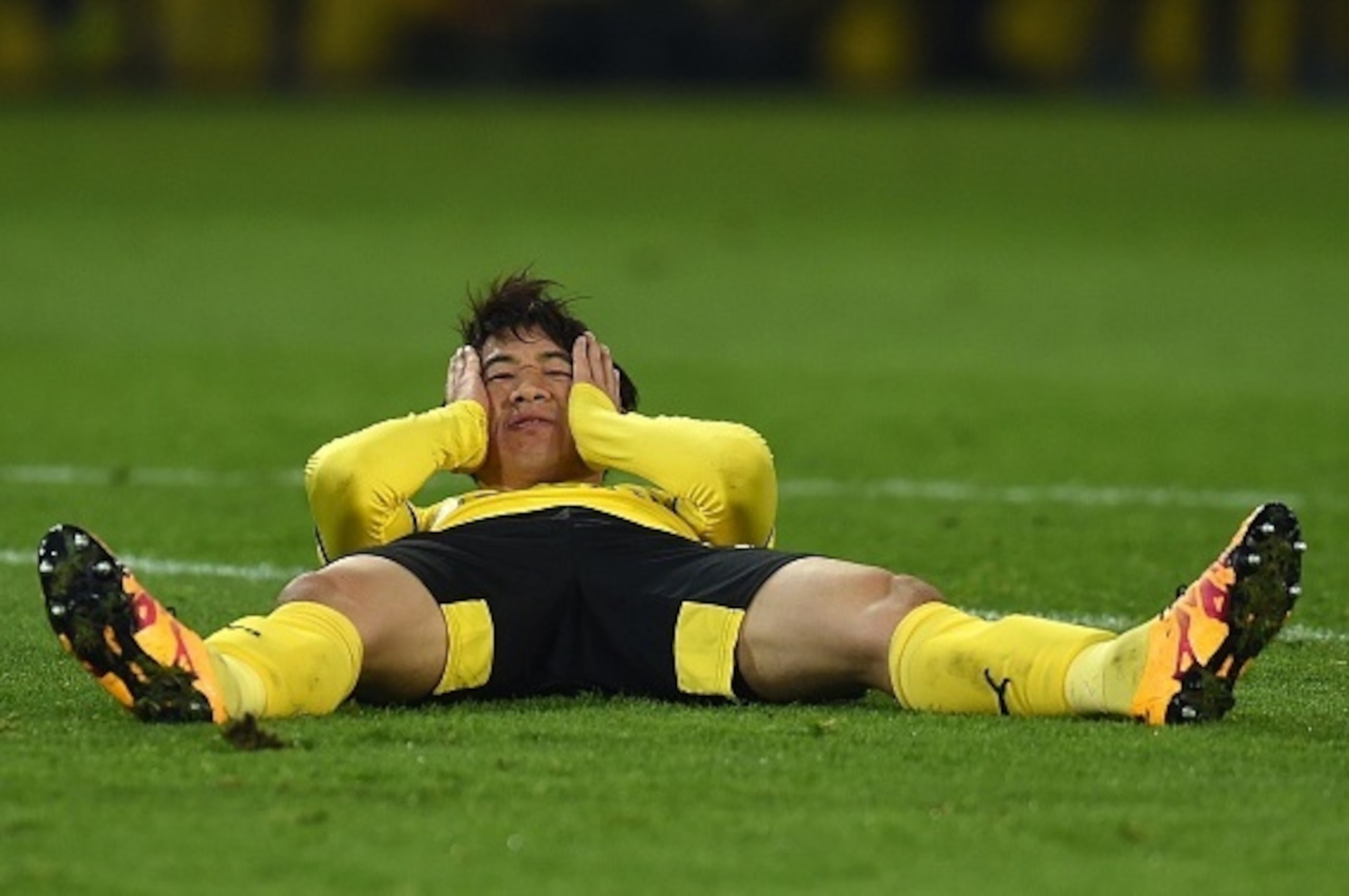 Dortmund's Japanese midfielder Shinji Kagawa reacts  during the UEFA Europa League Round of 32 football match between Borussia Dortmund and FC Porto in Dortmund, western Germany on February 18, 2016. 

 / AFP / PATRIK STOLLARZ        (Photo credit should 