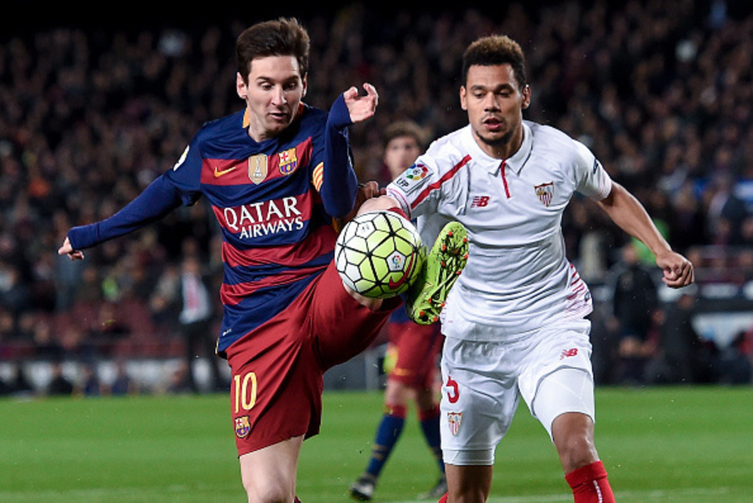 Barcelona's Argentinian forward Lionel Messi (L) vies with Sevilla's French defender Timothee Kolodziejczak during the Spanish league football match FC Barcelona vs Sevilla FC at the Camp Nou stadium in Barcelona on February 28, 2016. / AFP / JOSEP LAGO  