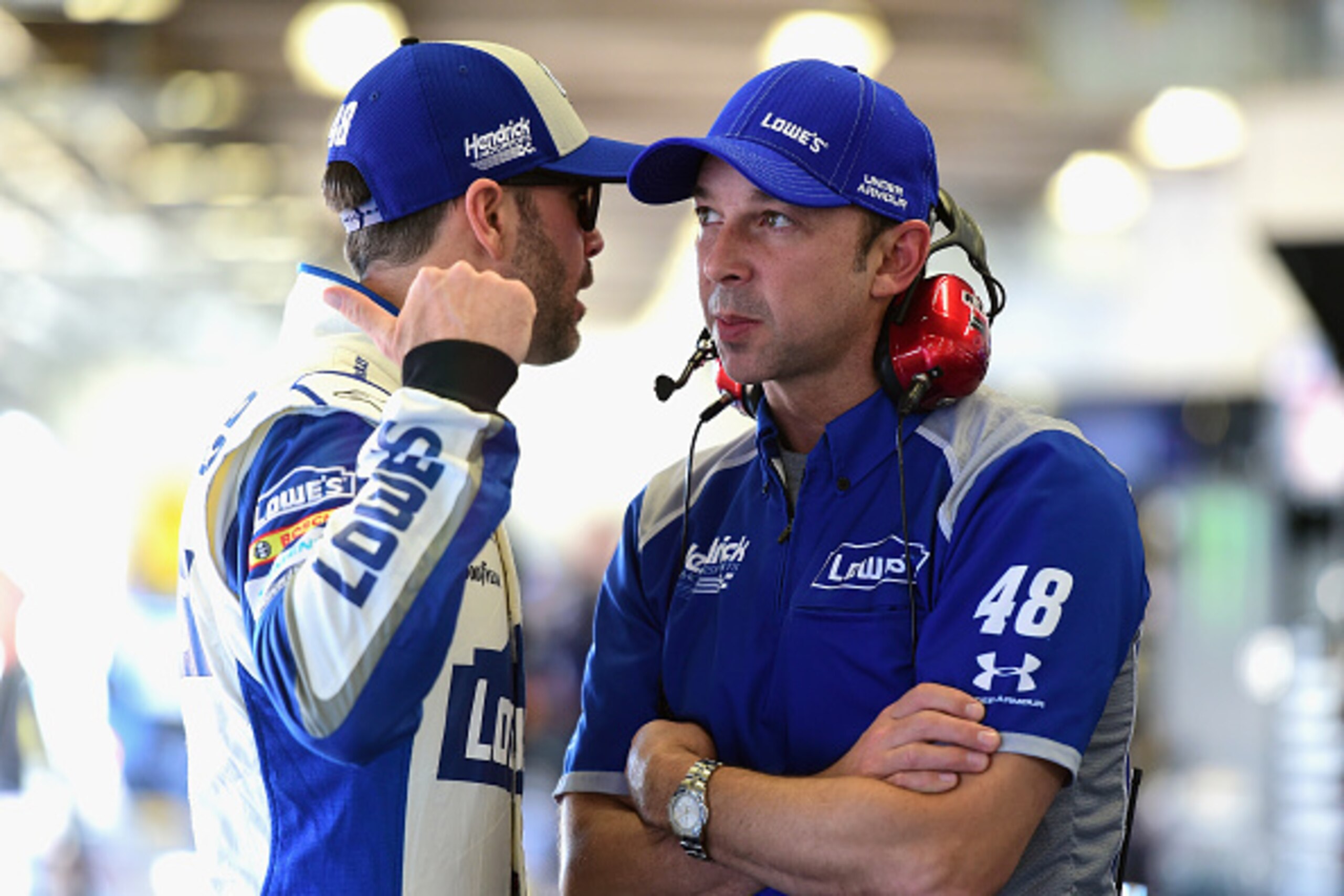 DAYTONA BEACH, FL - FEBRUARY 12:  Jimmie Johnson, driver of the #48 Lowe's Chevrolet, talks with crew chief Chad Knaus in the garage area during practice for the NASCAR Sprint Cup Series Sprint Unlimited at Daytona International Speedway on February 12, 2
