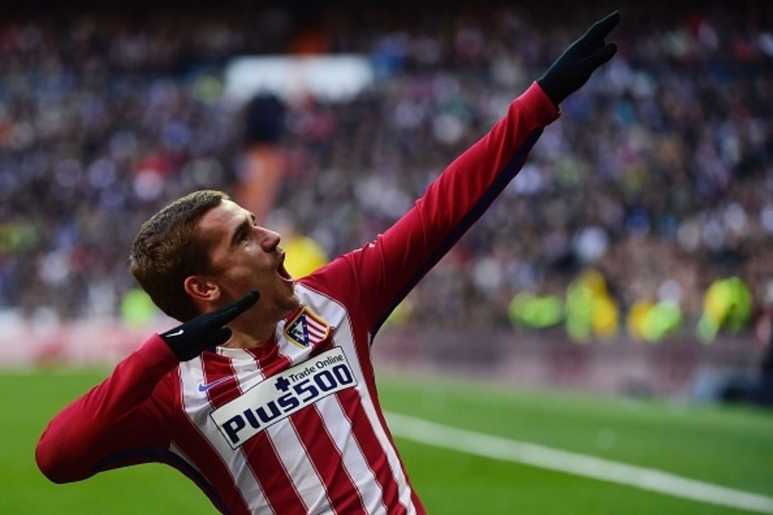 Atletico Madrid's French forward Antoine Griezmann celebrates after scoring during the Spanish league football match Real Madrid CF vs Atletico de Madrid at the Santiago Bernabeu stadium in Madrid on February 27, 2016. / AFP / PIERRE-PHILIPPE MARCOU      