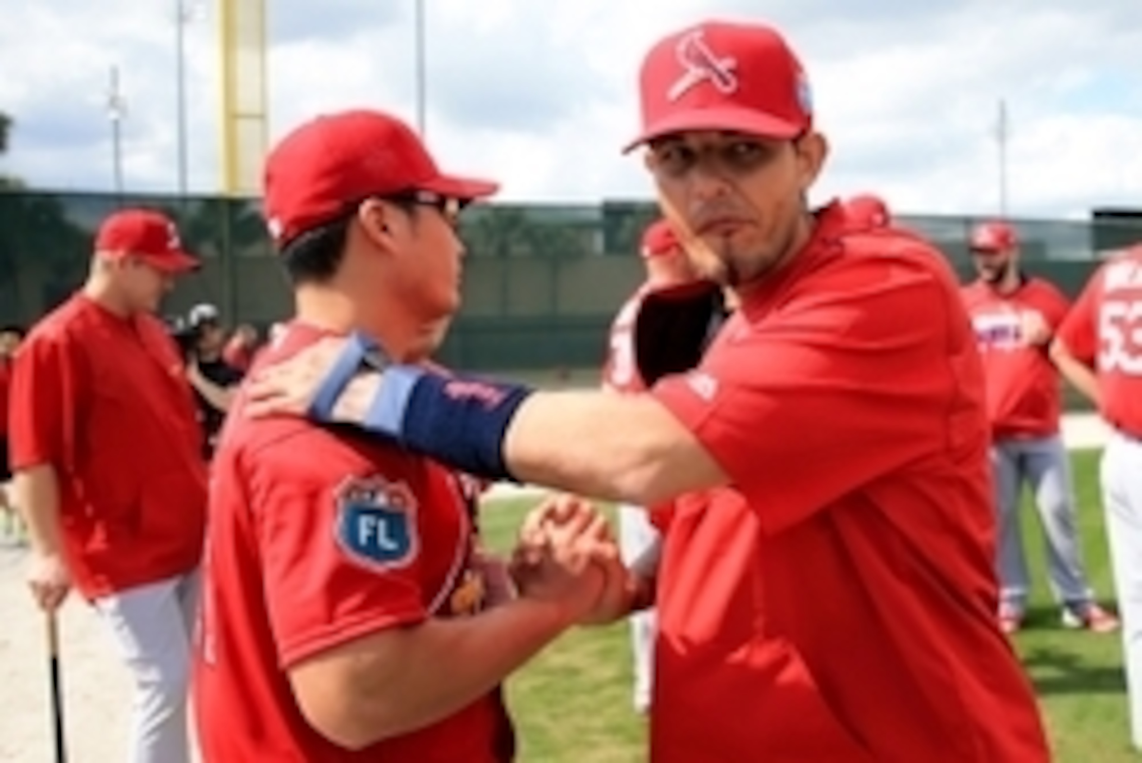 Feb 18, 2016; Jupiter, FL, USA; St. Louis Cardinals catcher Yadier Molina (right) greets relief pitcher Seung Hwan Oh (left) at Roger Dean Stadium. Mandatory Credit: Steve Mitchell-USA TODAY Sports
