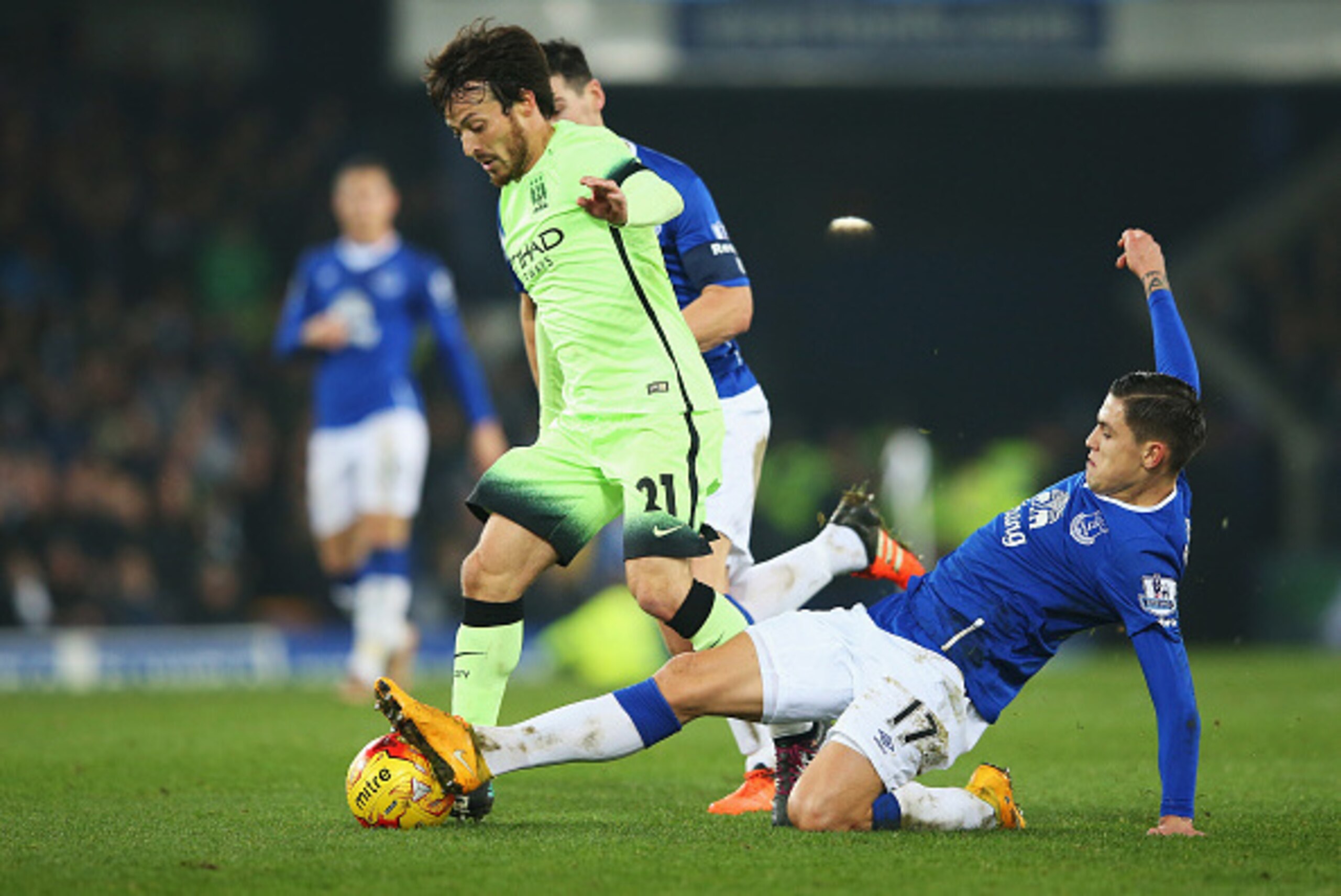 LIVERPOOL, ENGLAND - JANUARY 06:  David Silva of Manchester City is challenged by Muhamed Besic of Everton during the Capital One Cup Semi Final First Leg match between Everton and Manchester City at Goodison Park on January 6, 2016 in Liverpool, England.