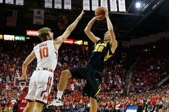 COLLEGE PARK, MD - JANUARY 28: Jarrod Uthoff #20 of the Iowa Hawkeyes puts up a shot over Jake Layman #10 of the Maryland Terrapins in the first half at Xfinity Center on January 28, 2016 in College Park, Maryland.  (Photo by Rob Carr/Getty Images)