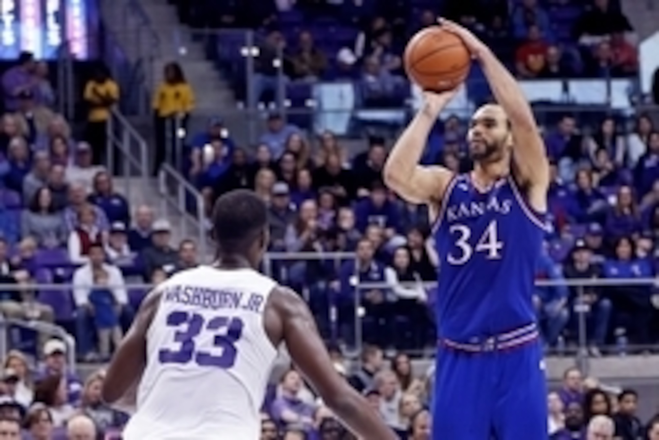 Feb 6, 2016; Fort Worth, TX, USA; Kansas Jayhawks forward Perry Ellis (34) shoots as TCU Horned Frogs forward Chris Washburn (33) defends during the second half at Ed and Rae Schollmaier Arena. Mandatory Credit: Kevin Jairaj-USA TODAY Sports