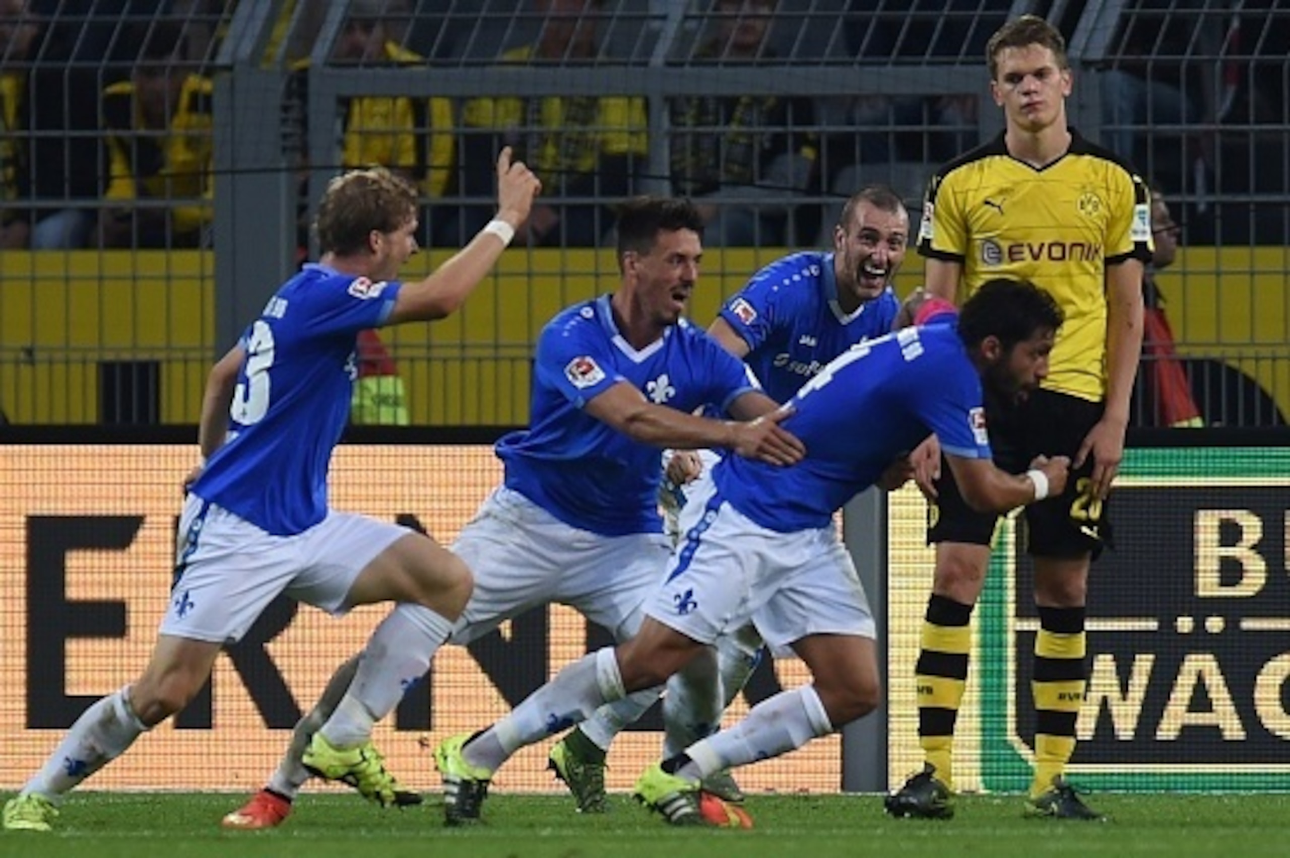 Darmstadt´s players celebrate scoring during the German first division Bundesliga football match Borussia Dortmund v SV Darmstadt 98, in Dortmund, western Germany, on September 27, 2015. The match ended with a 2-2 draw. AFP PHOTO / PATRIK STOLLARZ  RESTRI