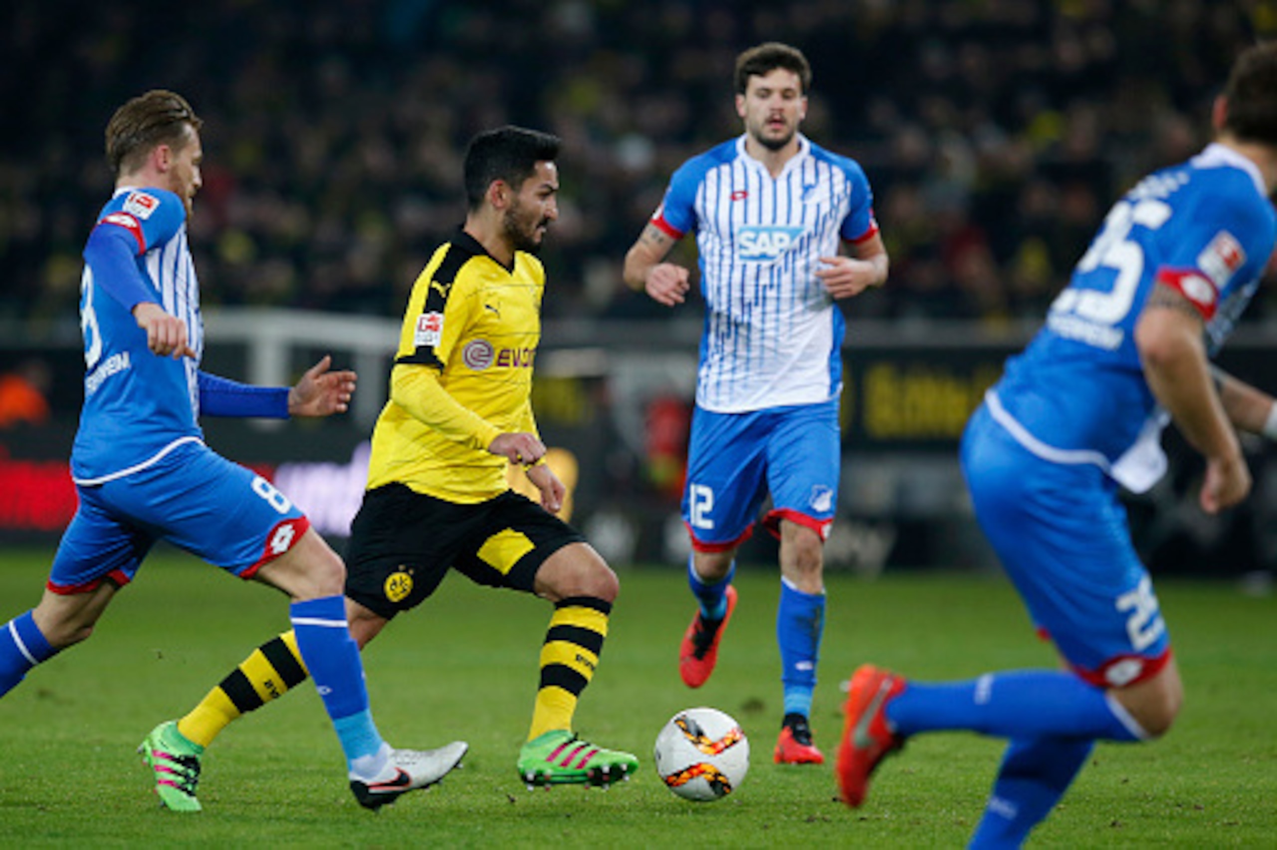 DORTMUND, GERMANY - FEBRUARY 28:  Ilkay Guendogan (C) of Borussia Dortmund is challenged by players of 1899 Hoffenheim during the Bundesliga match between Borussia Dortmund and 1899 Hoffenheim at Signal Iduna Park on February 28, 2016 in Dortmund, Germany