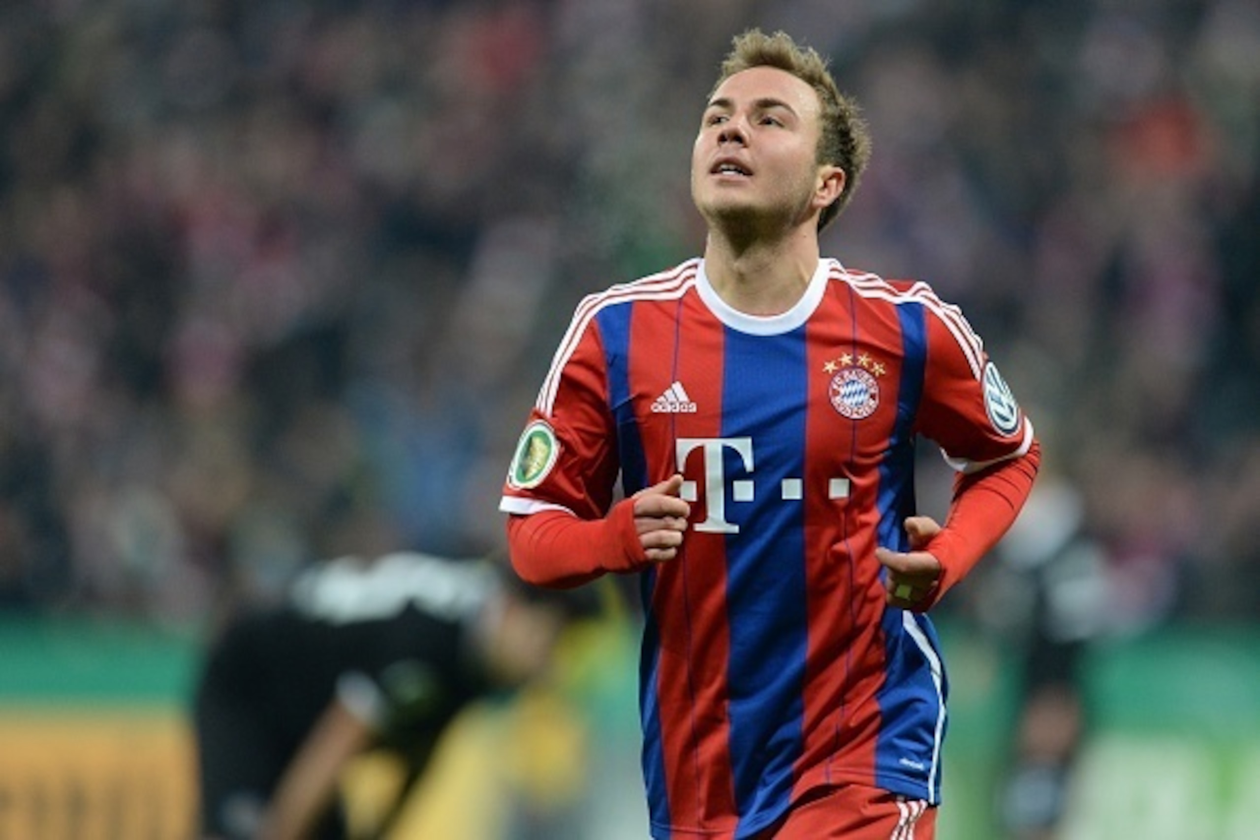 Bayern Munich's midfielder Mario Goetze celebrates scoring the 2-0 goal during the German football Cup DFB Pokal round of 16 match between German first division football club FC Bayern Munich and German second division football club Eintracht Braunschweig