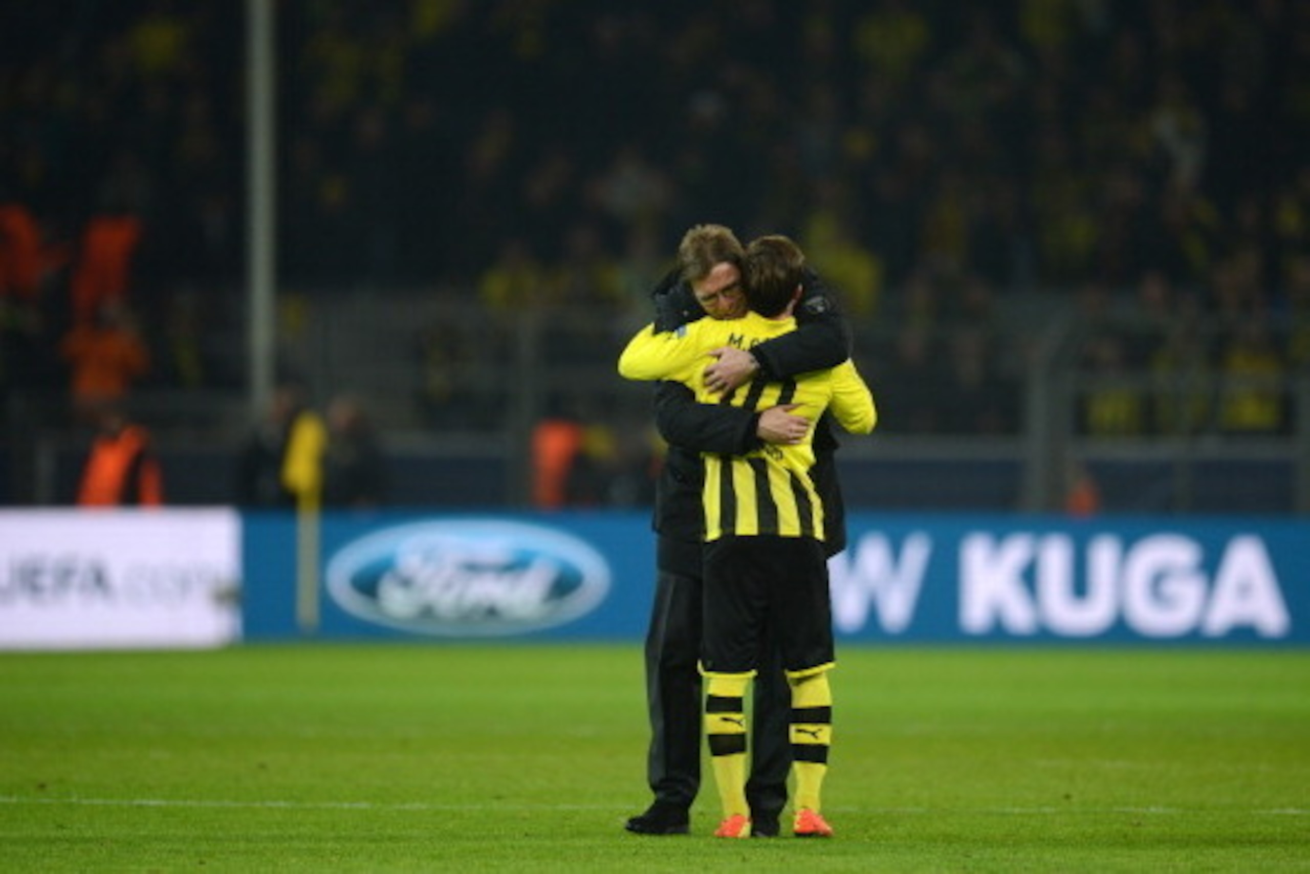 Dortmund's head coach Juergen Klopp (L) and Dortmund's midfielder Mario Goetze celebrate after the UEFA Champions League last 16, second leg match Borussia Dortmund vs Shakhtar Donetsk in Dortmund, western Germany, on March 5, 2013. Dortmund won the match
