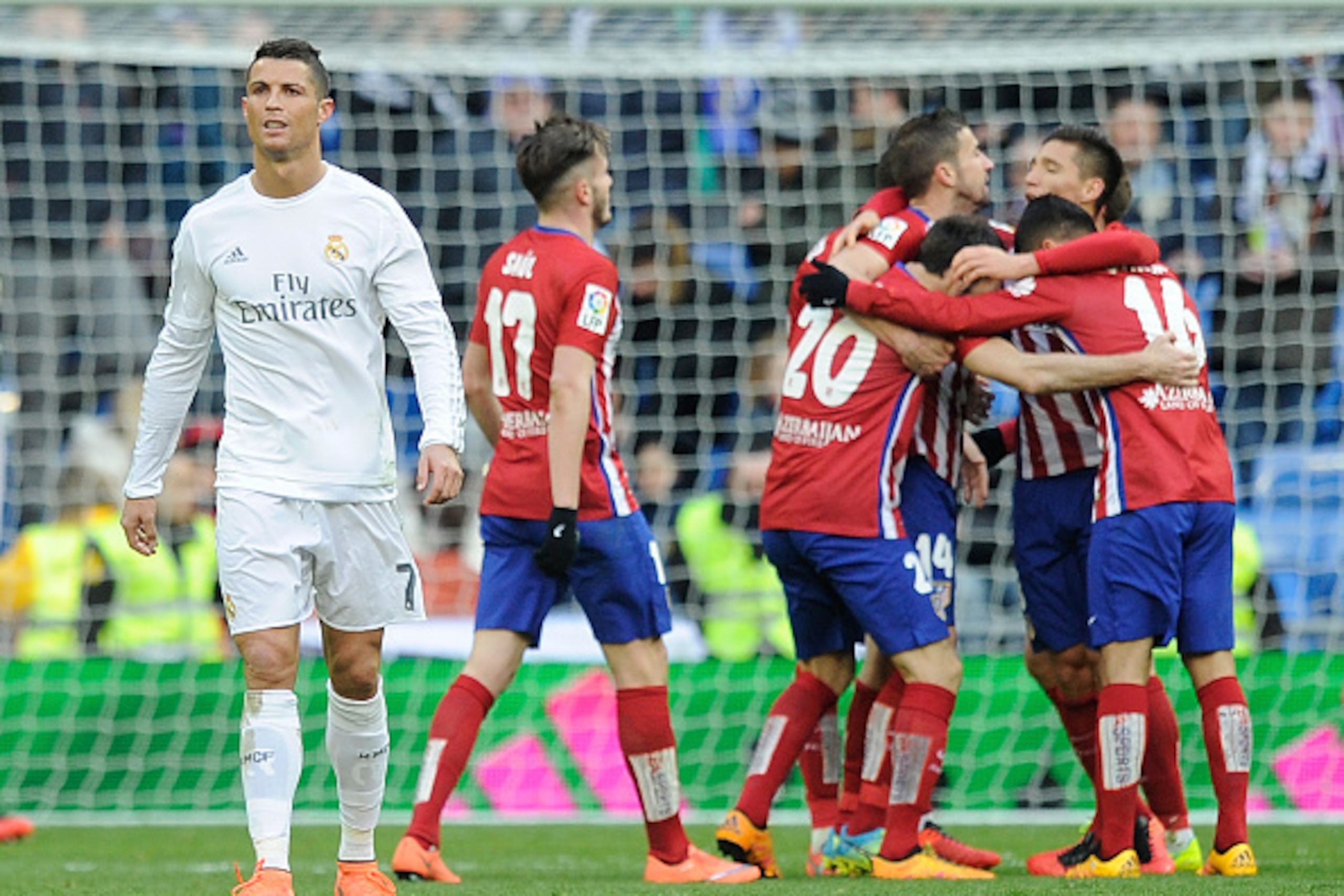 MADRID, SPAIN - FEBRUARY 27:  Cristiano Ronaldo of Real Madrid walks away from celebrating Atletico Madrid players after Atletico beat Real 1-0 in the La Liga match between Real Madrid CF and Club Atletico de Madrid at Estadio Santiago Bernabeu on Februar