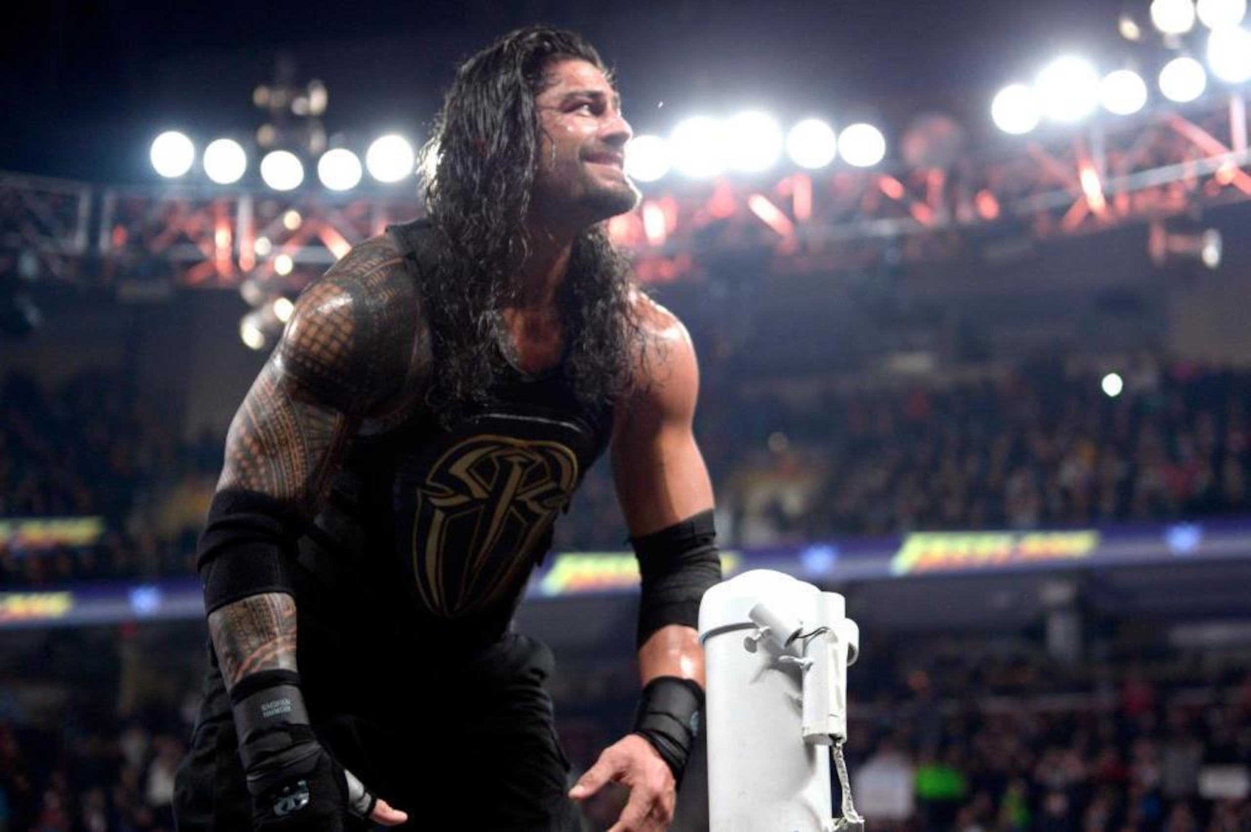Roman Reigns celebrates his win at Fastlane.
