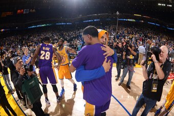 OAKLAND, CA - NOVEMBER 24: Stephen Curry #30 of the Golden State Warriors hugs Jordan Clarkson #6 of the Los Angeles Lakers after the Golden State Warriors win their 16th game in a row against the Los Angeles Lakers, breaking an NBA franchise record on No