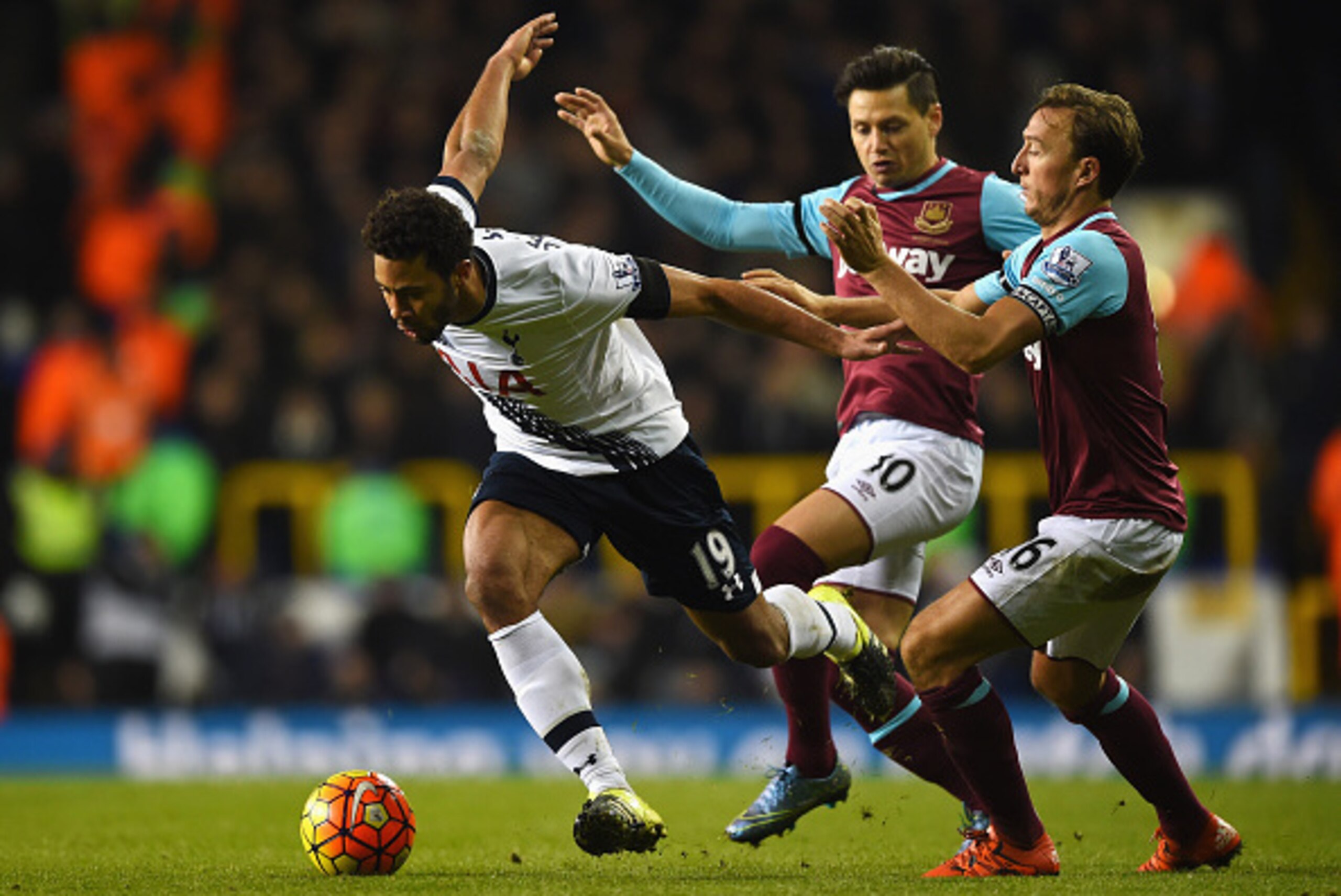 LONDON, ENGLAND - NOVEMBER 22: Mousa Dembele of Tottenham Hotspur goes past Mauro Zarate and Mark Noble of West Ham United during the Barclays Premier League match between Tottenham Hotspur and West Ham United at White Hart Lane on November 22, 2015 in Lo