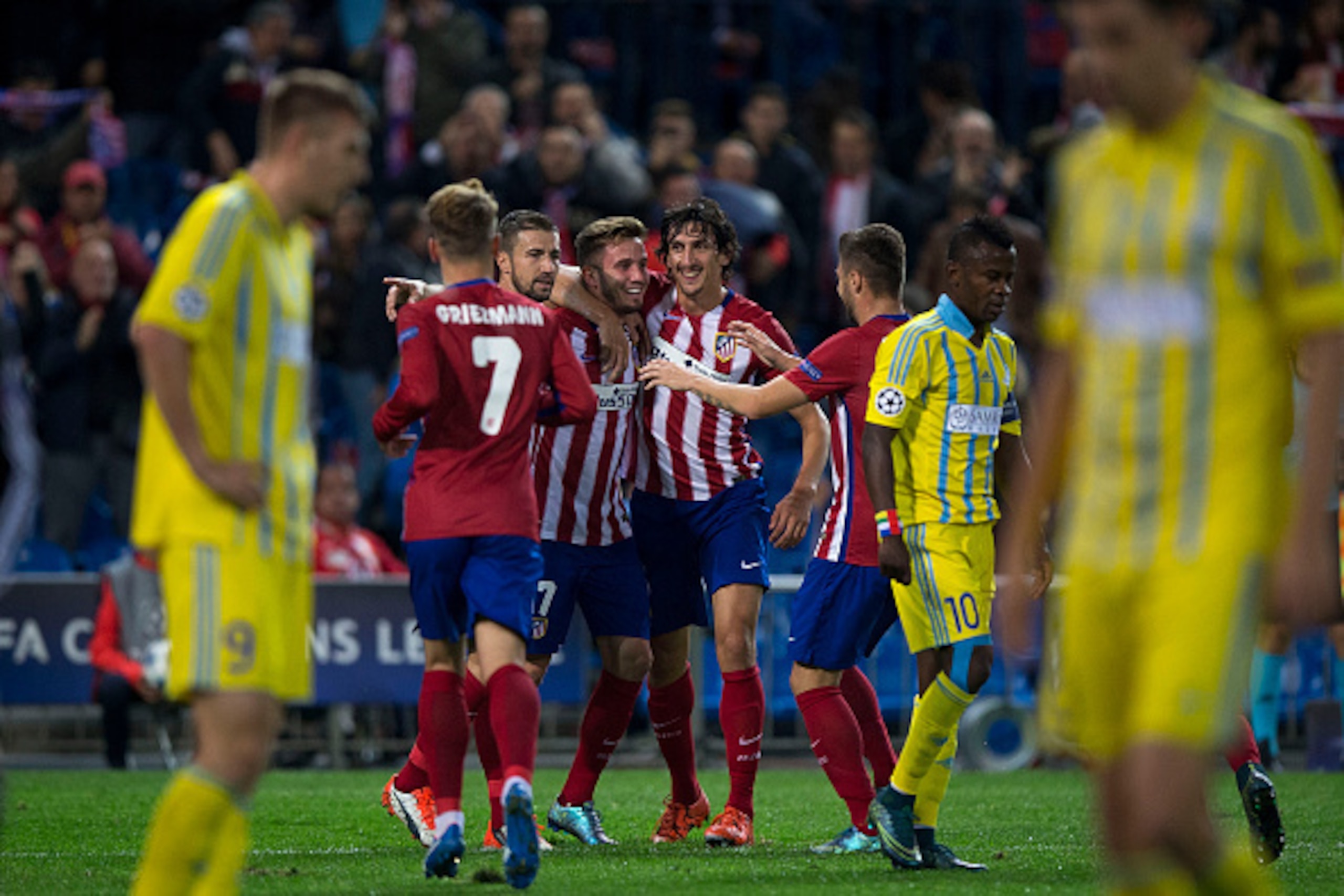 MADRID, SPAIN - OCTOBER 21: Saul Niguez (2ndR) celebrates scoring their opening goal with teammates Gabi Fernandez (L) and Stefan Savic (R) during the UEFA Champions League Group C match between Club Atletico de Madrid and FC Astana at Vicente Calderon s MADRID, SPAIN - OCTOBER 21: Saul Niguez (2ndR) celebrates scoring their opening goal with teammates Gabi Fernandez (L) and Stefan Savic (R) during the UEFA Champions League Group C match between Club Atletico de Madrid and FC Astana at Vicente Calderon s