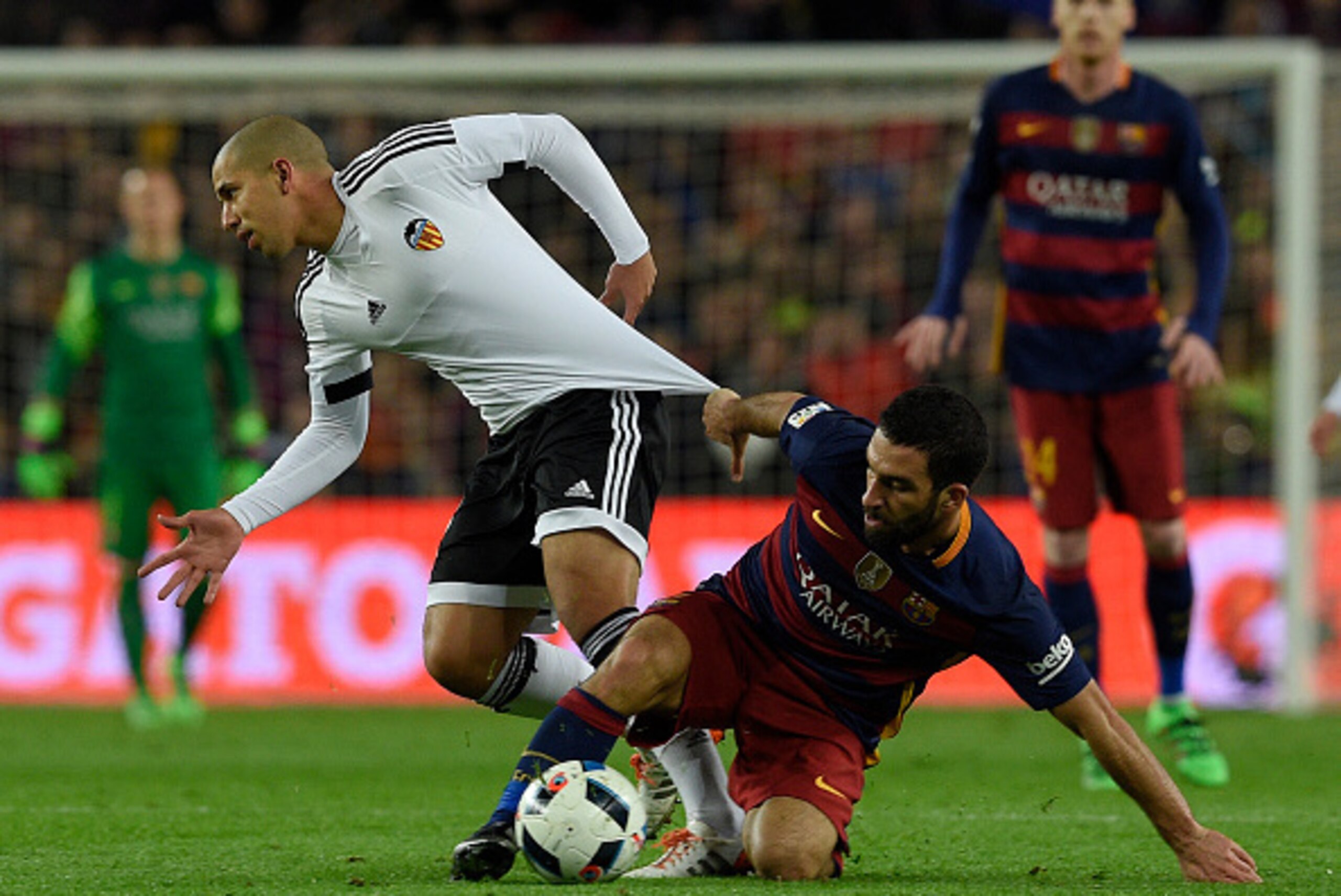Barcelona's Turkish midfielder Arda Turan (R) vies with Valencia's French midfielder Sofiane Feghouli (L) during the Spanish Copa del Rey (King's Cup) football match FC Barcelona vs Valencia CF at the Camp Nou stadium in Barcelona on February 3, 2016.   A