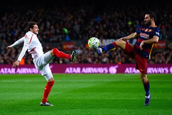BARCELONA, SPAIN - FEBRUARY 28: Arda Turan of FC Barcelona competes for the ball with Sebastian Cristoforo of Sevilla FC during the La Liga match between FC Barcelona and Sevilla FC at Camp Nou on February 28, 2016 in Barcelona, Spain.  (Photo by David Ra