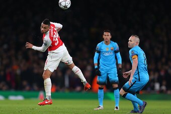 LONDON, ENGLAND - FEBRUARY 23 :  Francis Coquelin of Arsenal heads past Andres Iniesta of FC Barcelona  during the UEFA Champions League match between Arsenal and Barcelona at the Emirates Stadium on February 23, 2016 in London, United Kingdom.  (Photo by