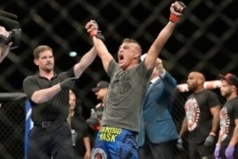 Jun 7, 2014; Albuquerque, NM, USA; Diego Sanchez (red) celebrates his victory over Ross Pearson (blue) after their lightweight bout during UFC Fight Night 42 at Tingley Coliseum. Sanchez won via split decision. Mandatory Credit: Joe Camporeale-USA TODAY S