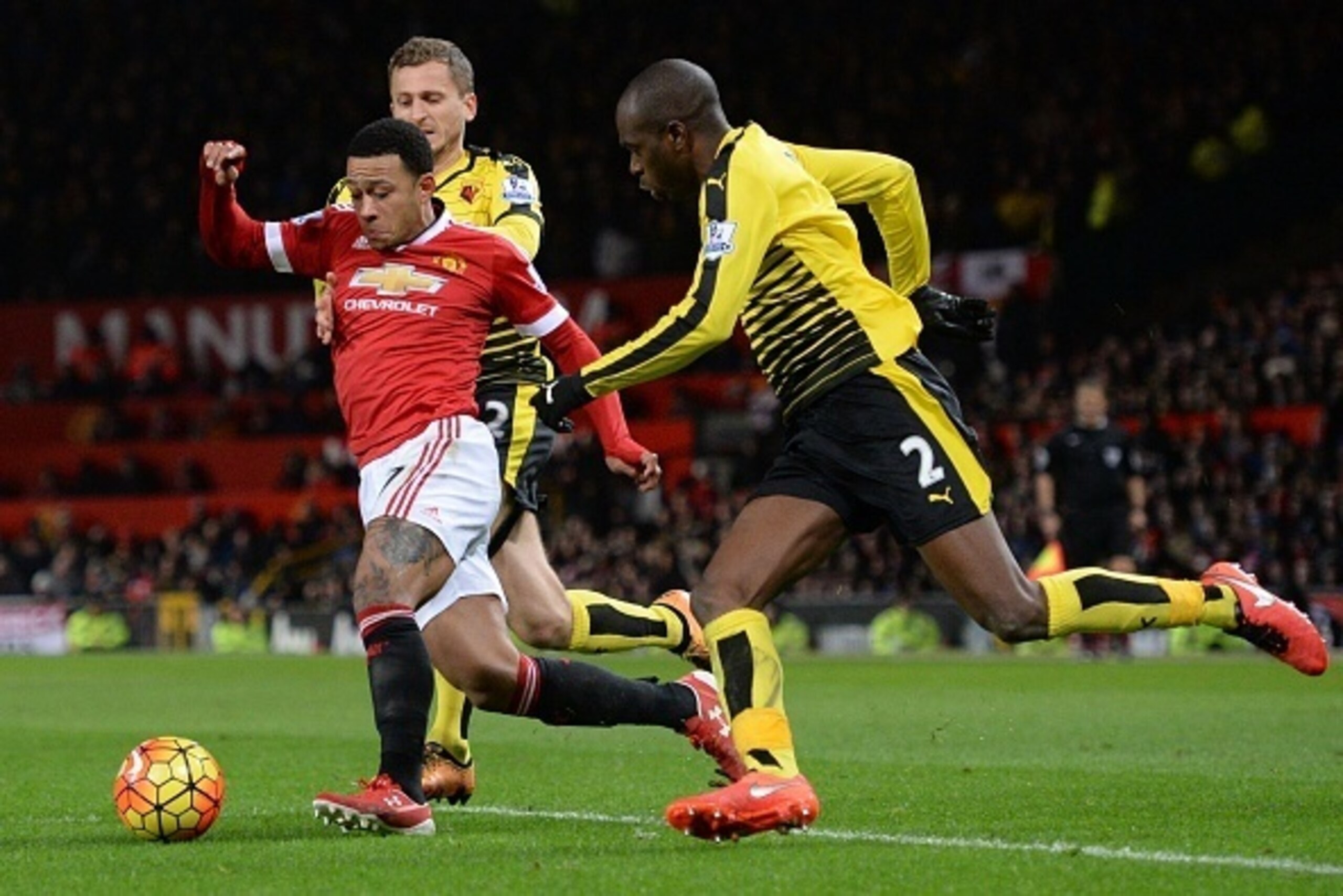 Manchester United's Dutch midfielder Memphis Depay (L) weaves between Watford's Cameroonian defender Allan Nyom (R) and Watford's Yugoslavian-born Swiss midfielder Almen Abdi (2L) during the English Premier League football match between Manchester United 