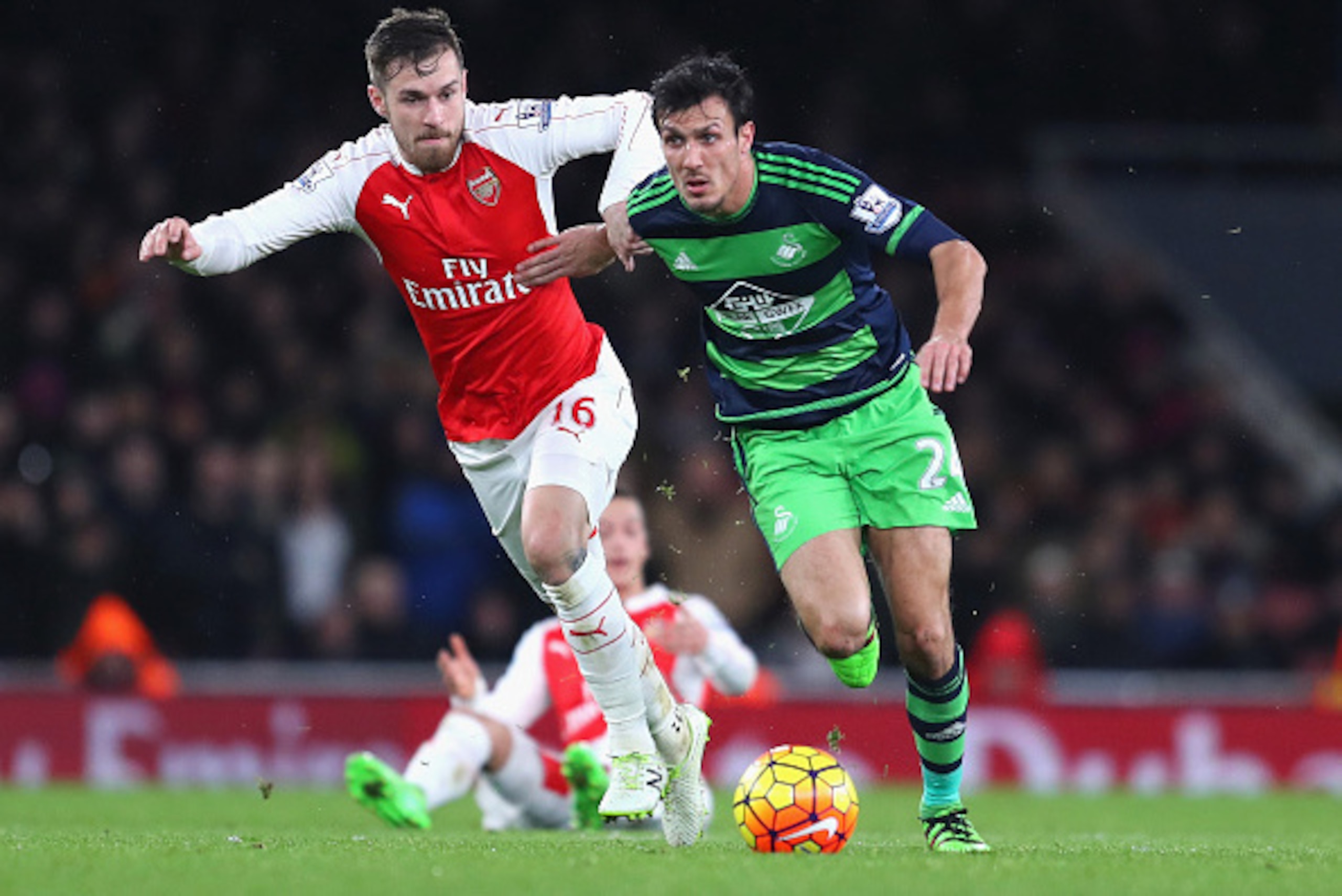 LONDON, ENGLAND - MARCH 02: Jack Cork of Swansea City and Aaron Ramsey of Arsenal challenge for the ball during the Barclays Premier League match between Arsenal and Swansea City at the Emirates Stadium on March 2, 2016 in London, England.  (Photo by Rich