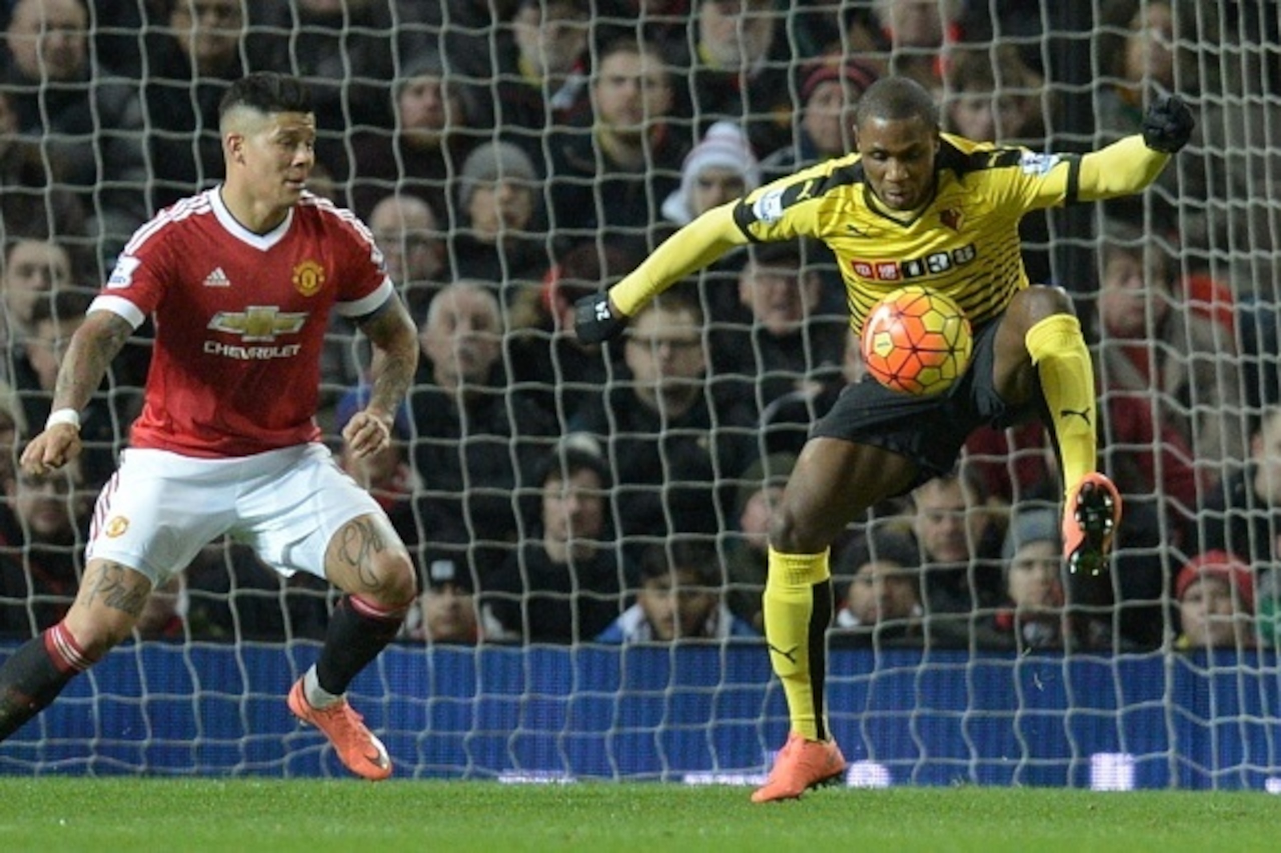 Watford's Nigerian striker Odion Ighalo (R) controls the ball as Manchester United's Argentinian defender Marcos Rojo (L) comes across to challenge during the English Premier League football match between Manchester United and Watford at Old Trafford in M