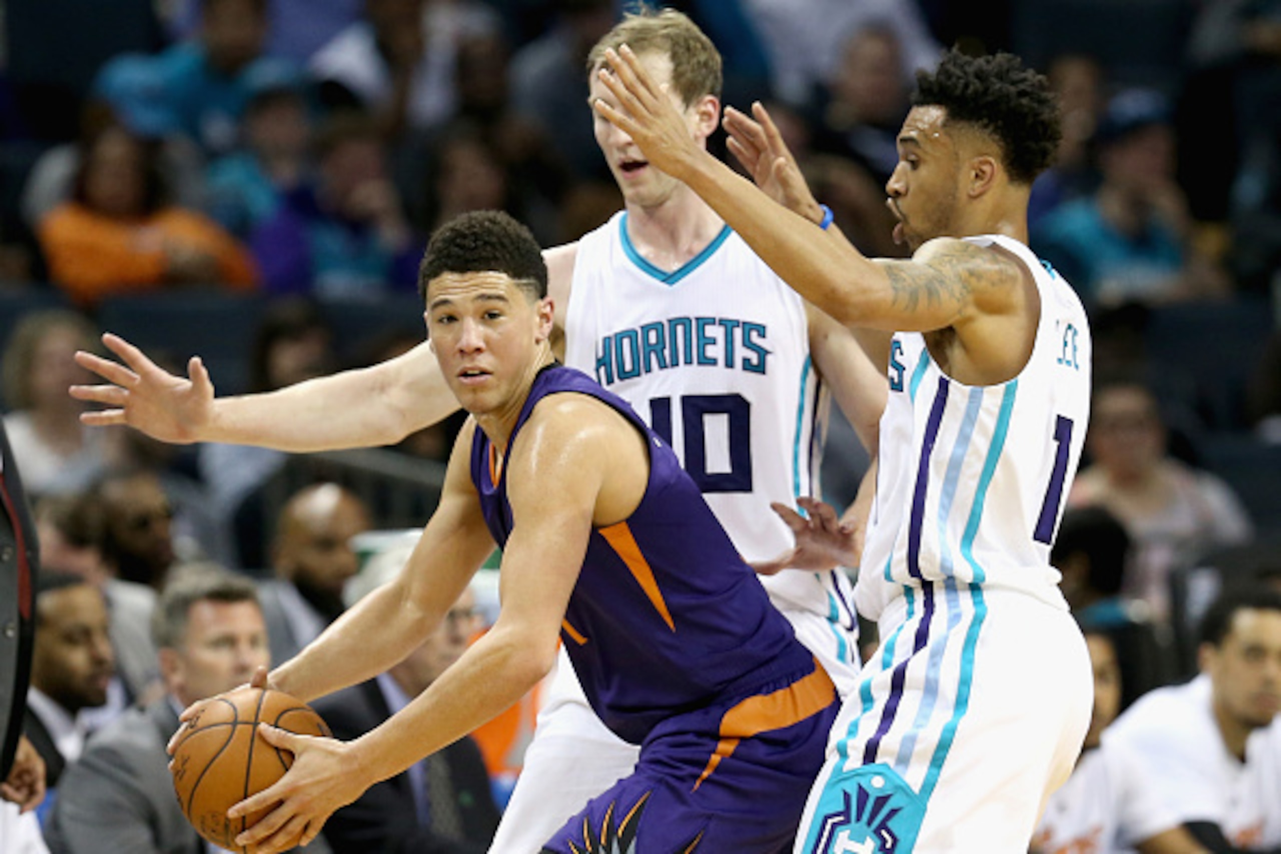 CHARLOTTE, NC - MARCH 01:  Devin Booker #1 of the Phoenix Suns is trapped by teammates Cody Zeller #40 and Courtney Lee #1 of the Charlotte Hornets during their game at Time Warner Cable Arena on March 1, 2016 in Charlotte, North Carolina.  NOTE TO USER: 
