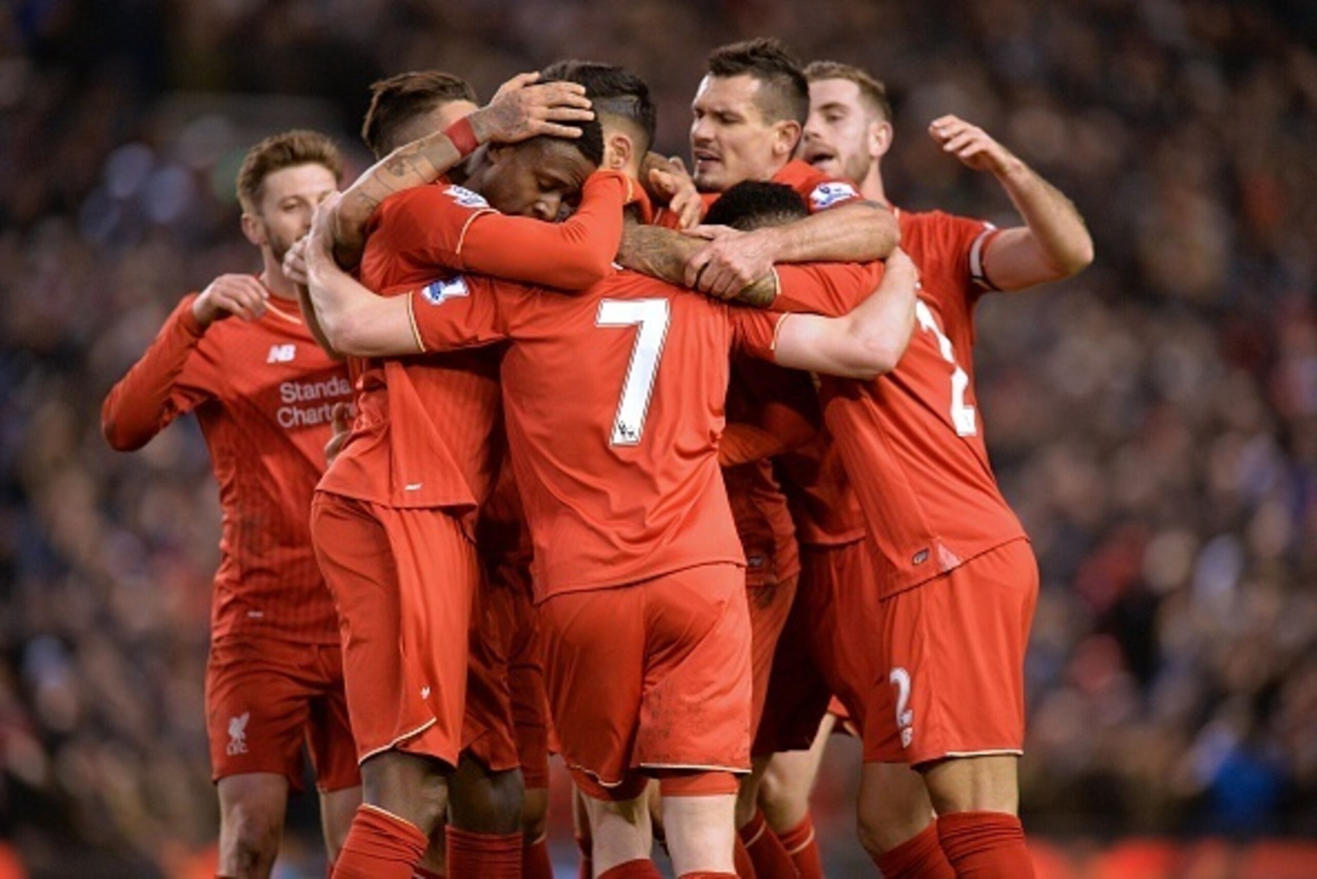 English midfielder James Milner celebrates with teammates after scoring their second goal during the English Premier League football match between Liverpool and Manchester City at Anfield in Liverpool, north west England on March 2, 2016. / AFP / Paul ELL