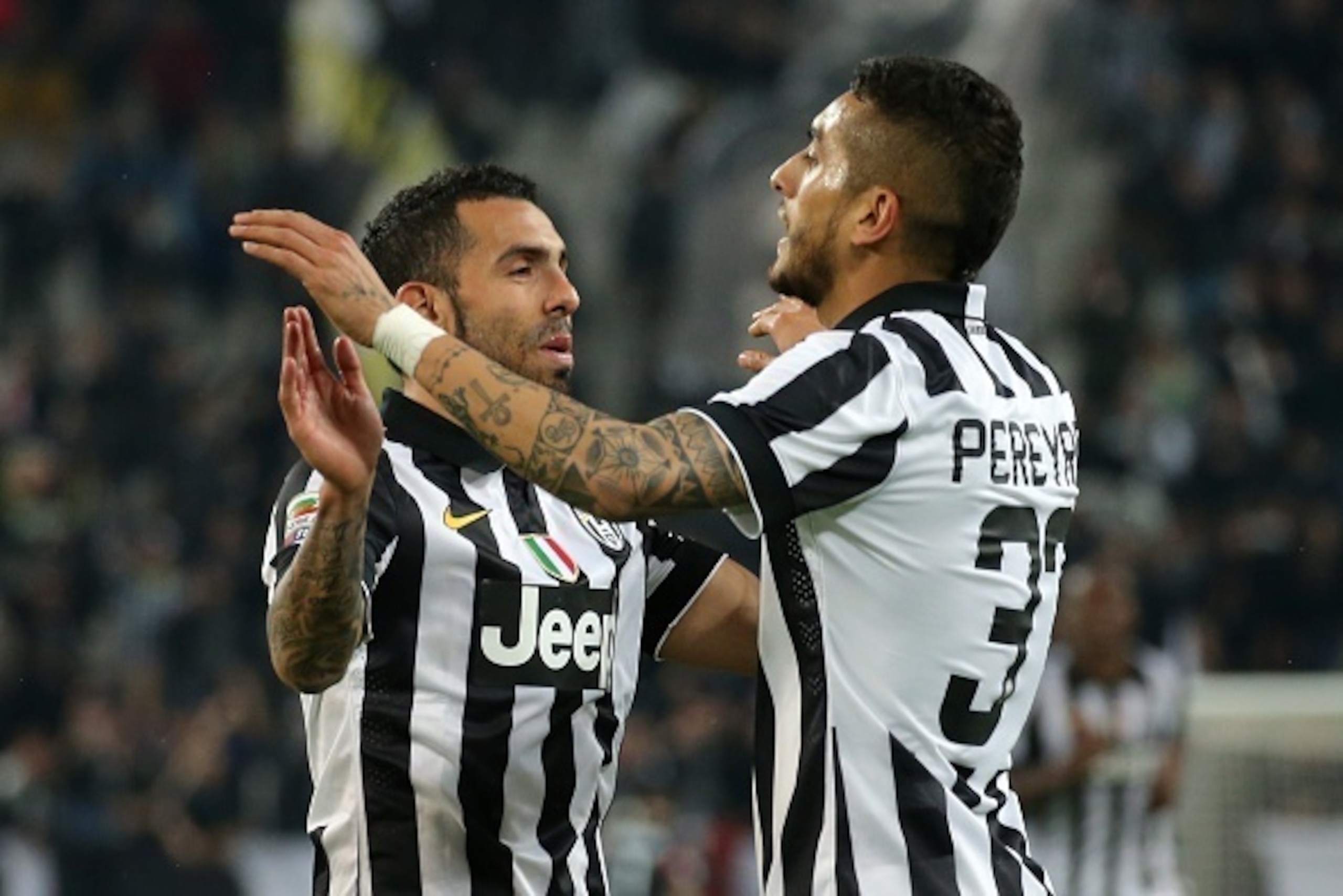 Juventus' midfielder Roberto Maxilimiano Pereyra (R ) of Argentina celebrates with Juventus' Argentinian forward Alberto Carlos Tevez after scoring during the Italian Serie A football match Juventus Vs Empoli on April 4, 2015 at the 'Juventus Stadium' in 