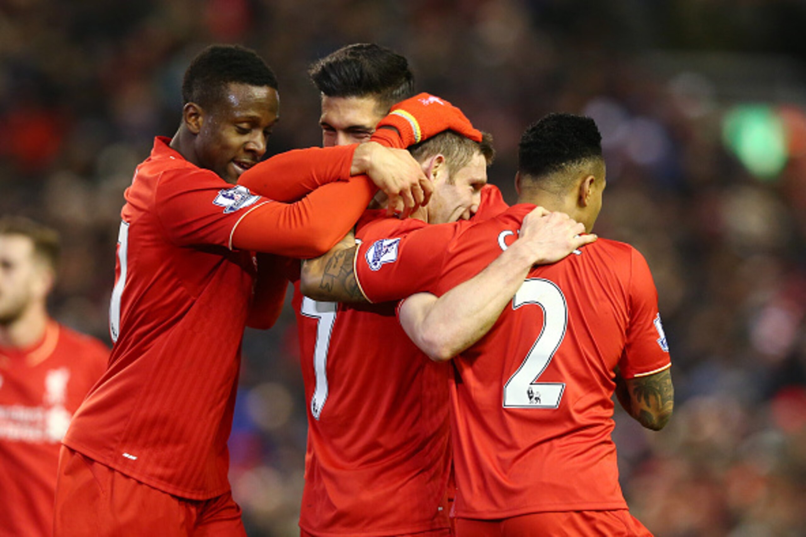LIVERPOOL, ENGLAND - MARCH 02:  James Milner of Liverpool is mobbed by teammates in celebration (Divock Origil (l) and Nathaniel Clyne (r)) after scoring his sides second goal during the Barclays Premier League match between Liverpool and Manchester City 
