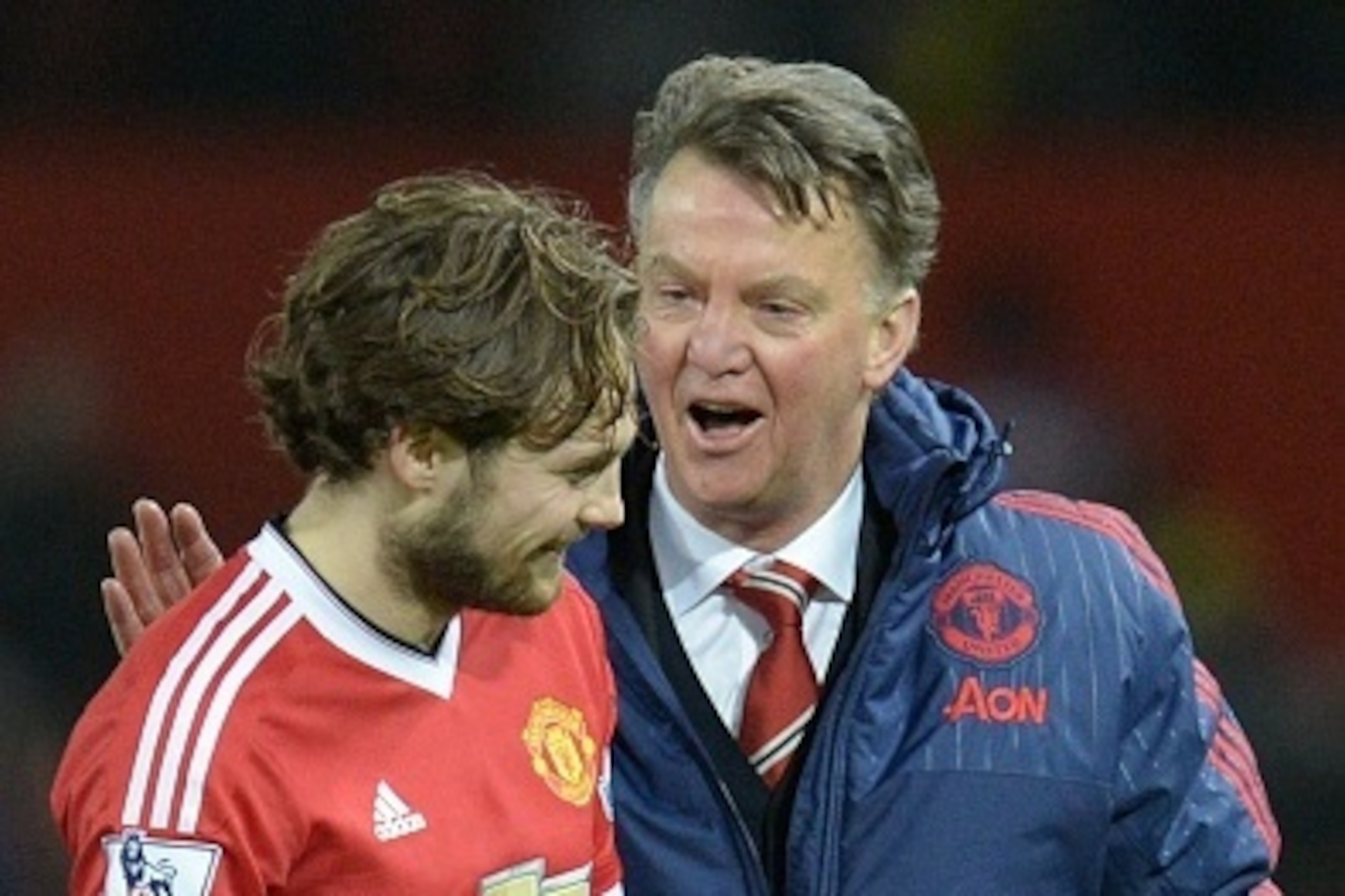 Manchester United's Dutch manager Louis van Gaal (R) talks with Manchester United's Dutch midfielder Daley Blind (L) at the end of the English Premier League football match between Manchester United and Watford at Old Trafford in Manchester in north west 