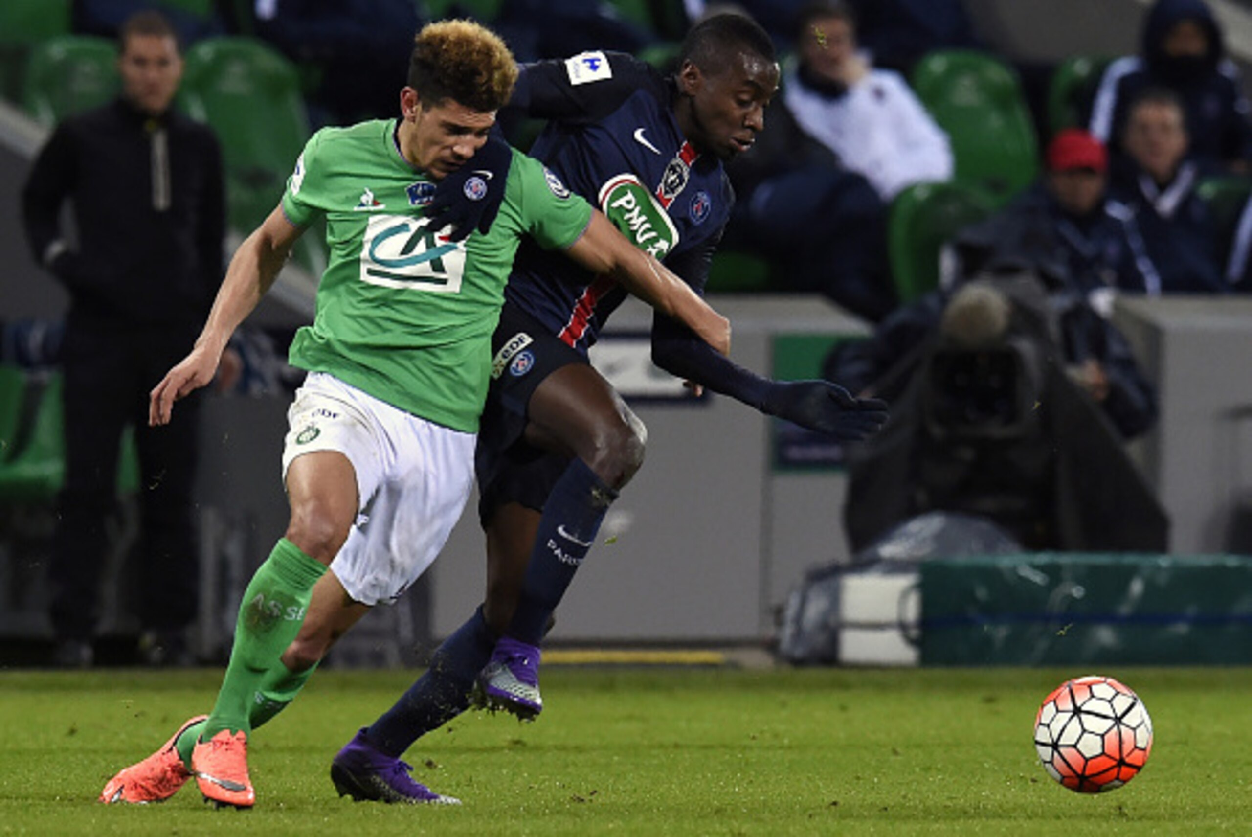 Saint-Etienne's French defender Kevin Malcuit (L) vies with Paris Saint-Germain's French midfielder Blaise Matuidi (R) during the French Cup quarter final football match between Saint-Etienne and Paris Saint-Germain, on March 2, 2016 at the Geoffroy Guich