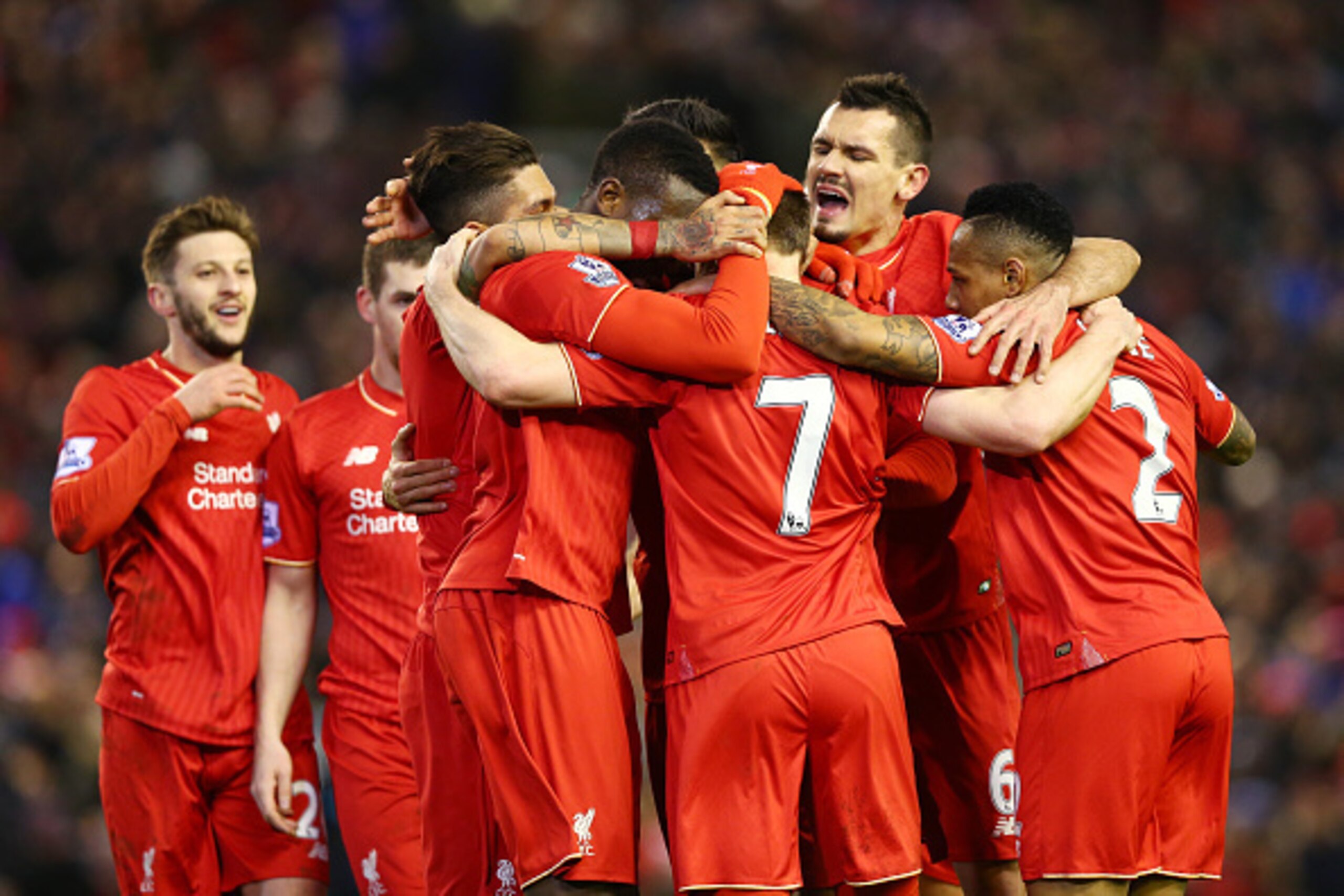 LIVERPOOL, ENGLAND - MARCH 02:  James Milner of Liverpool is mobbed by teammates in celebration after scoring his sides second goal during the Barclays Premier League match between Liverpool and Manchester City at Anfield on March 2, 2016 in Liverpool, En
