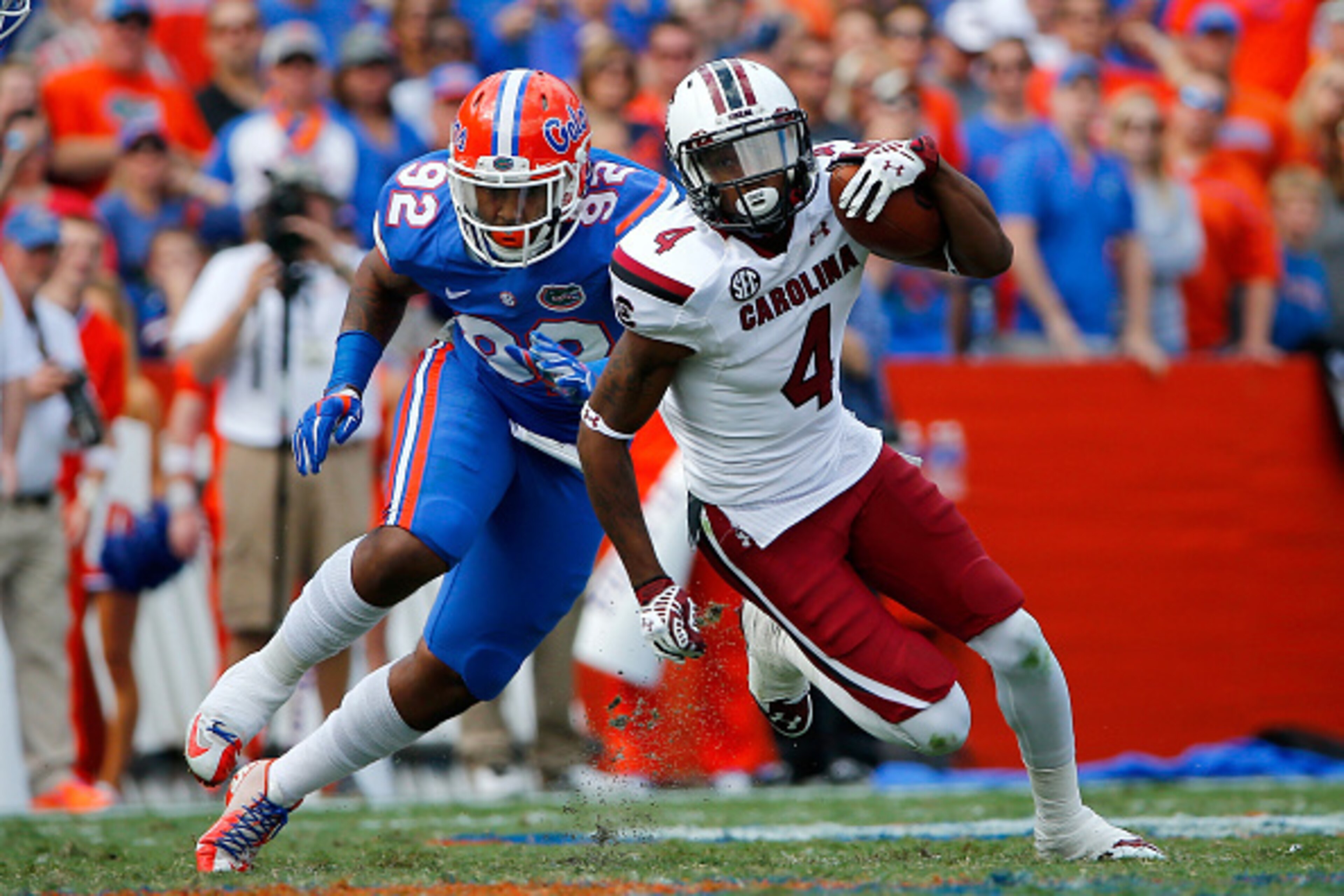 GAINESVILLE, FL - NOVEMBER 15:  Shaq Roland #4 of the South Carolina Gamecocks runs past Gerald Willis #92 of the Florida Gators during the game at Ben Hill Griffin Stadium on November 15, 2014 in Gainesville, Florida.  (Photo by Sam Greenwood/Getty Image