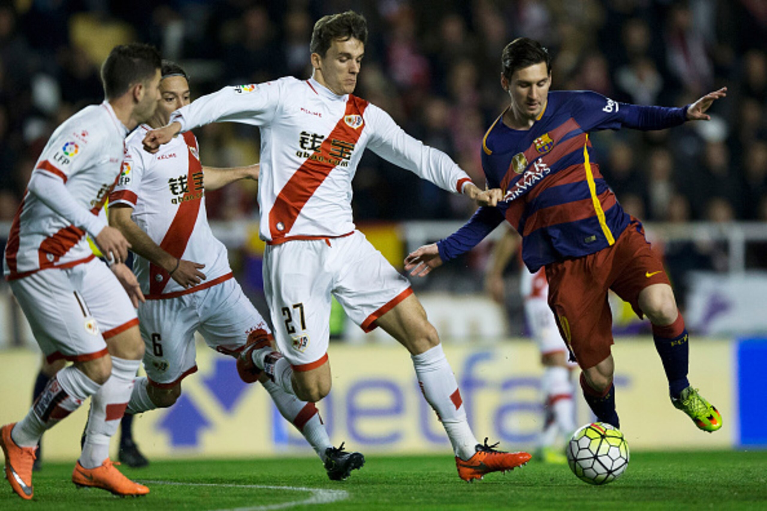 MADRID, SPAIN - MARCH 03: Lionel Messi (R) of FC Barcelona competes for the ball with Diego Llorente (2ndR) of Rayo Vallecano de Madrid during the La Liga match between Rayo Vallecano de Madrid and FC Barcelona at Estadio de Vallecas on March 3, 2016 in M