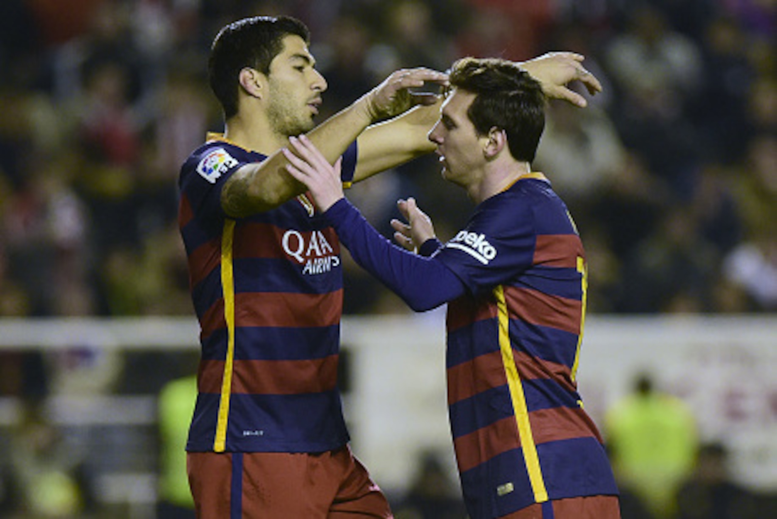 Barcelona's Argentinian forward Lionel Messi (R) celebrates after scoring with Barcelona's Uruguayan forward Luis Suarez during the Spanish league football match CF Rayo Vallecano vs FC Barcelona at the Vallecas stadium in Madrid on March 3, 2016. / AFP /