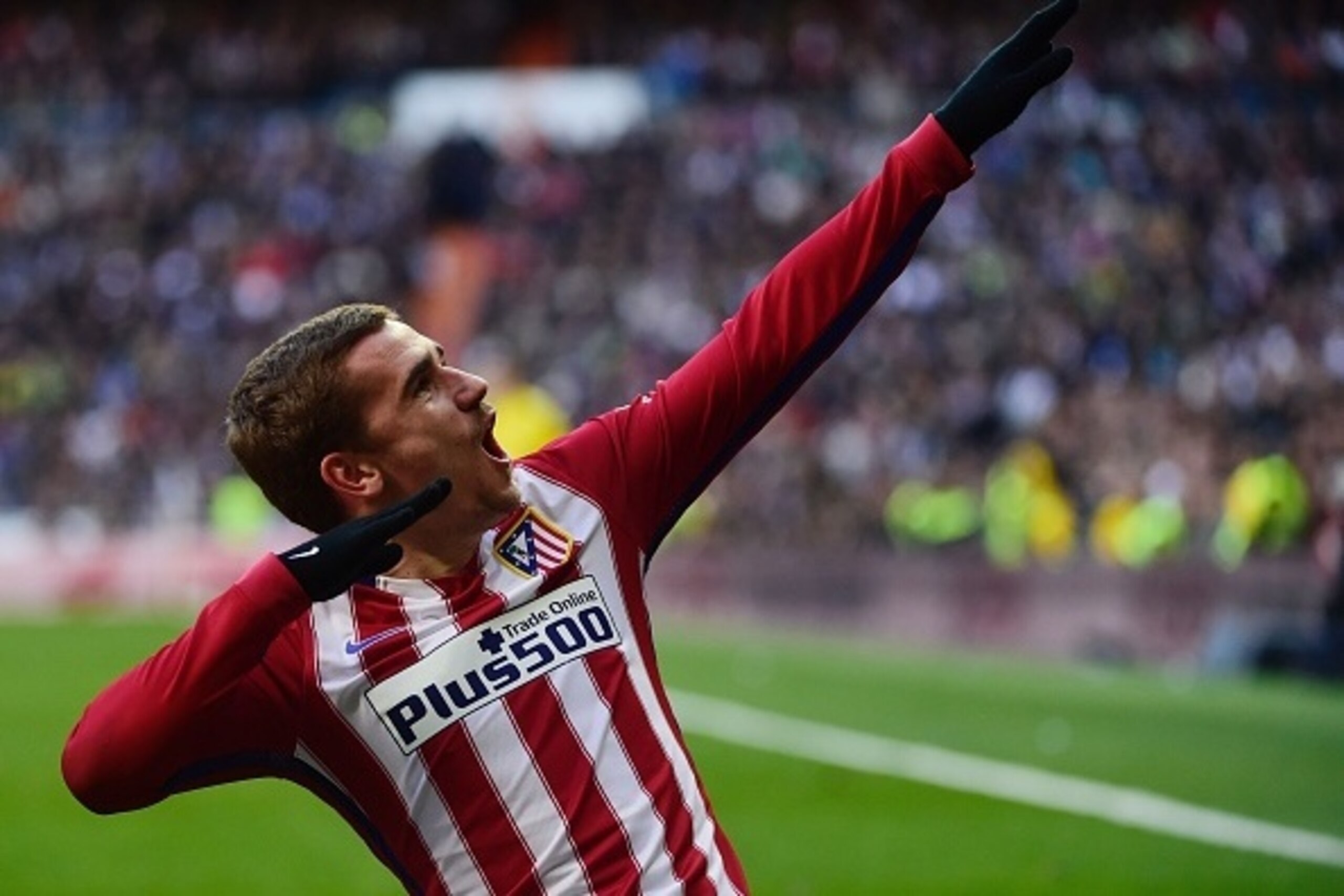 Atletico Madrid's French forward Antoine Griezmann celebrates after scoring during the Spanish league football match Real Madrid CF vs Atletico de Madrid at the Santiago Bernabeu stadium in Madrid on February 27, 2016. / AFP / PIERRE-PHILIPPE MARCOU      